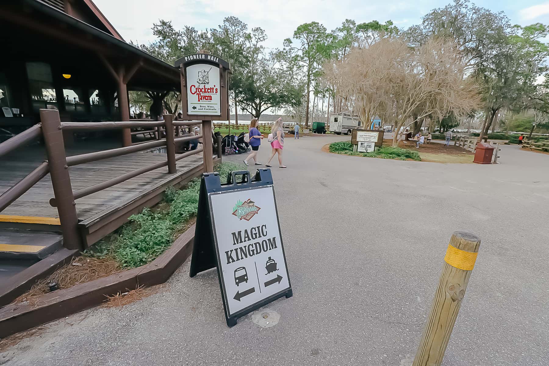 Sign says bus or boat from Fort Wilderness to Magic Kingdom. 