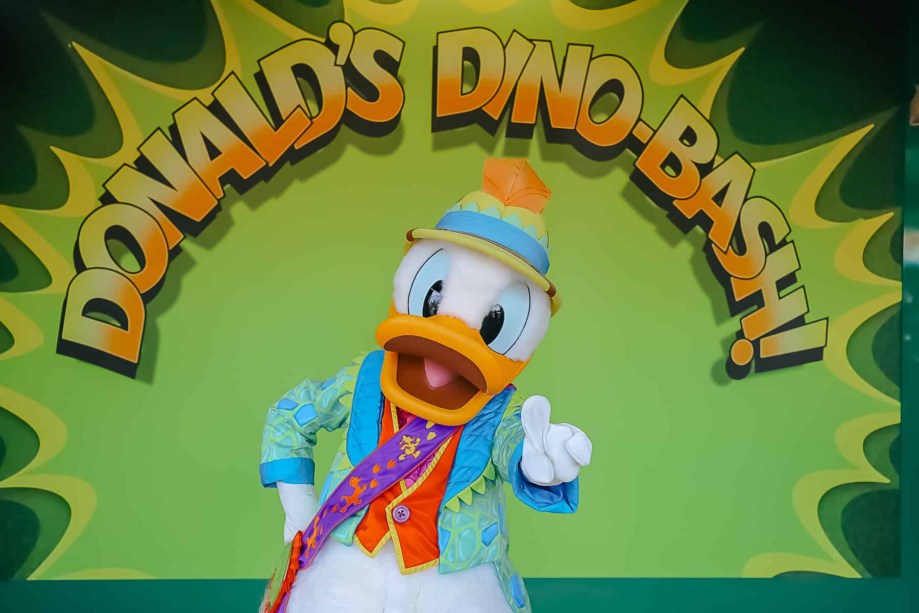 Donald Duck in his prehistoric costume poses with the number 1 