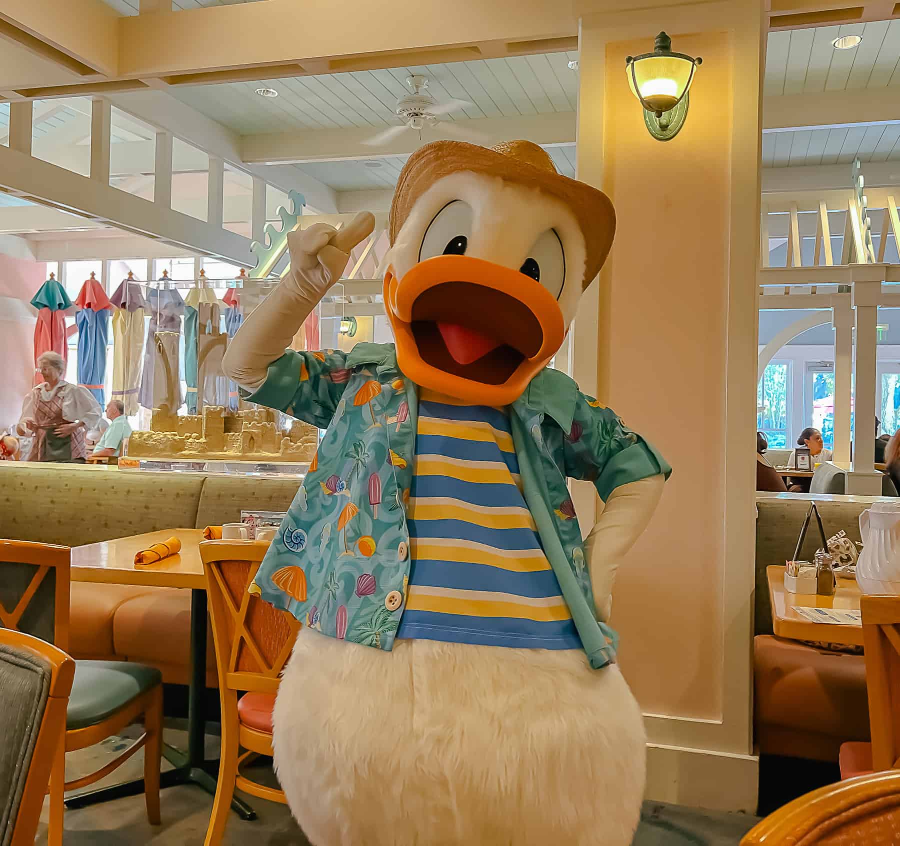 Donald Duck poses in a striped shirt with button up over it at Cape May Cafe 