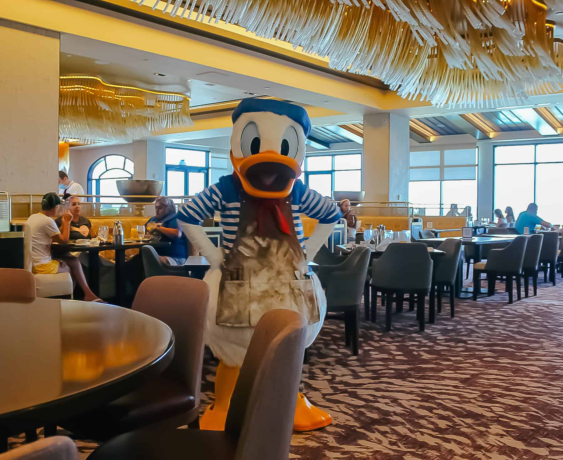 Donald Duck in blue white striped shirt and sculptor's apron 