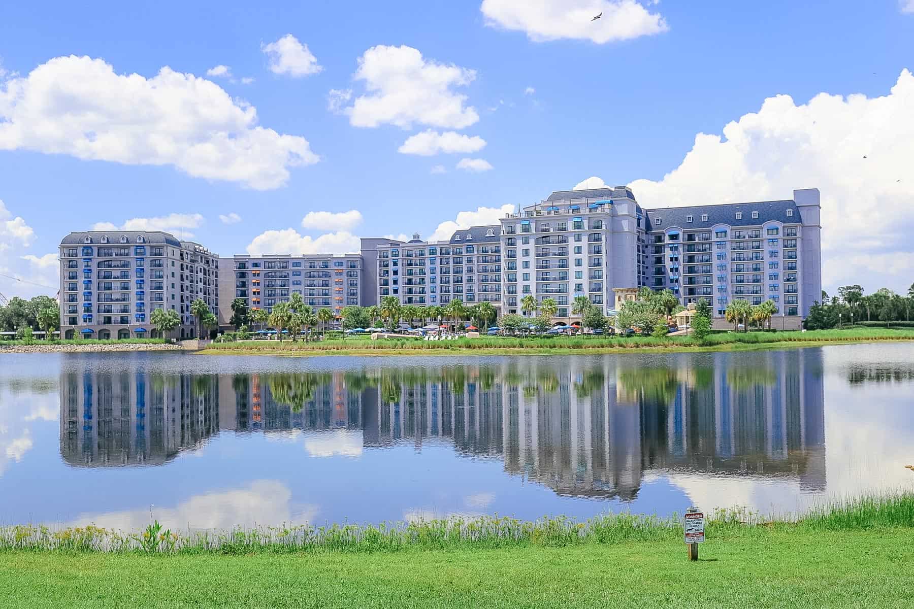 a photo that shows a reflection of Disney's Riviera Resort in the lake at Barefoot Bay