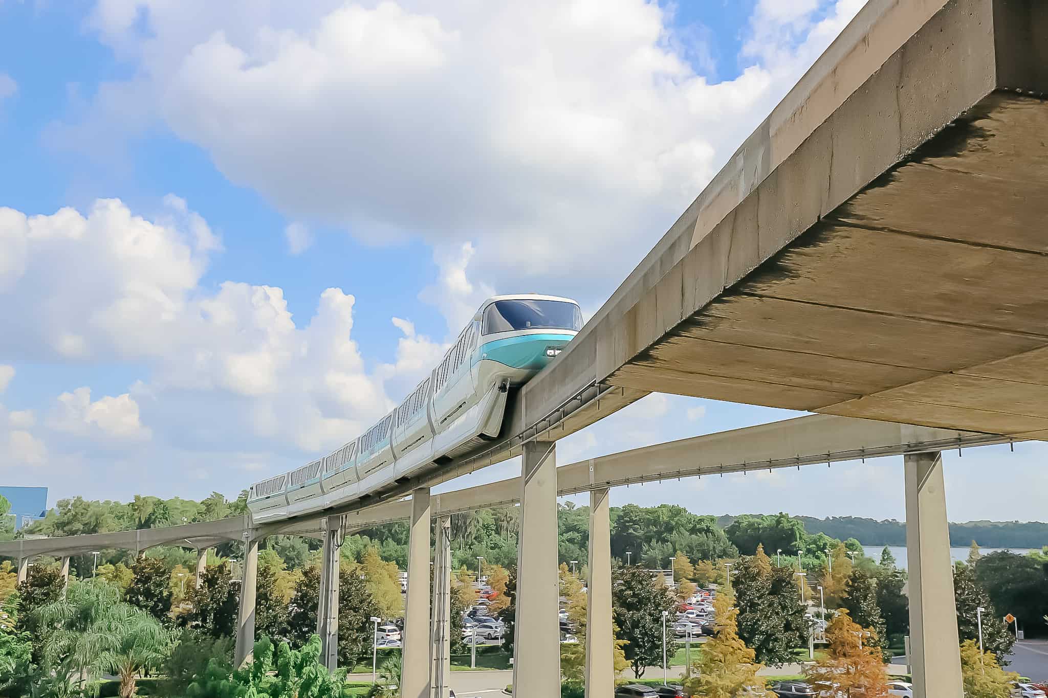 a teal monorail that's left the Magic Kingdom and entering the Contemporary 