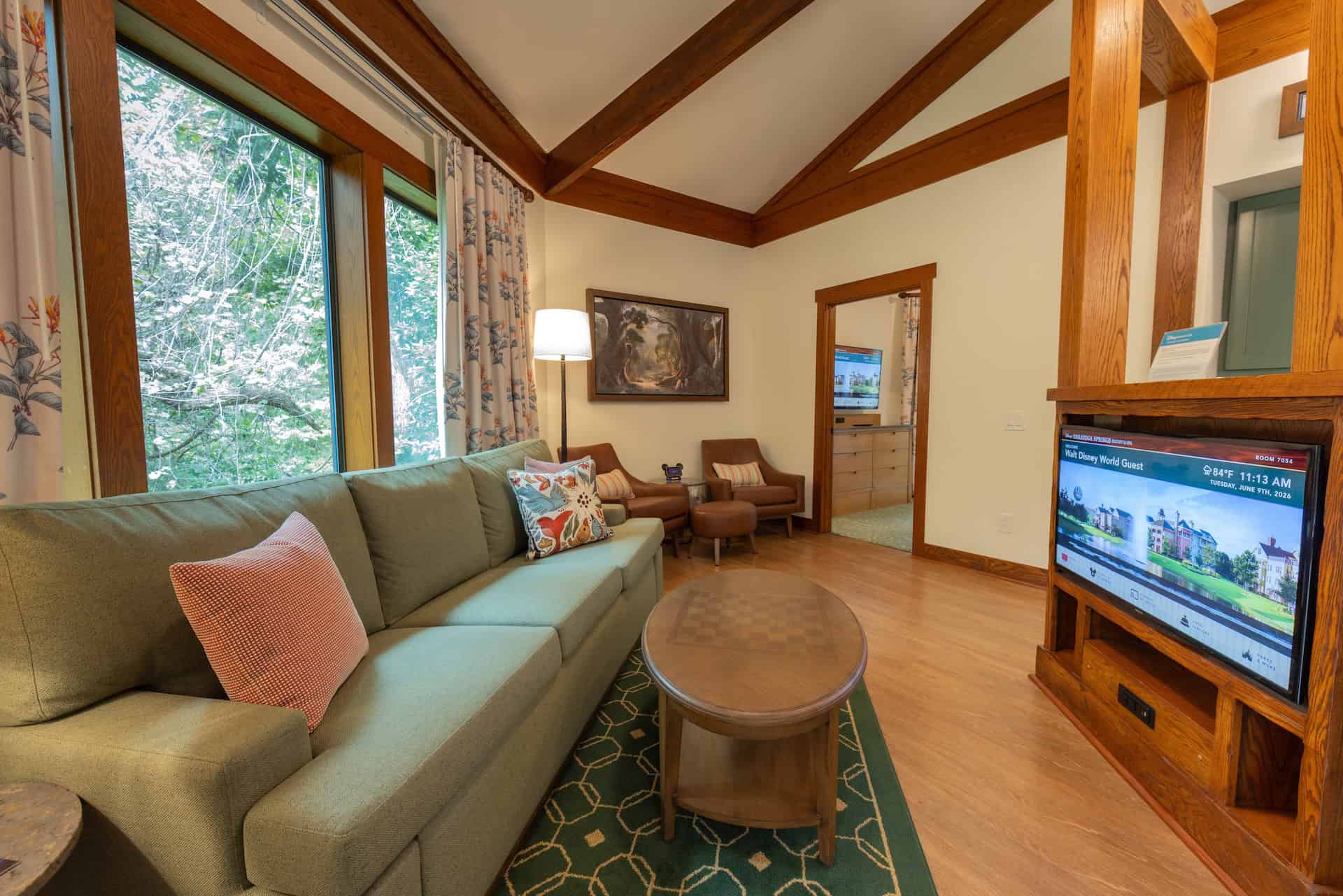 the sofa and television in a Treehouse Villa