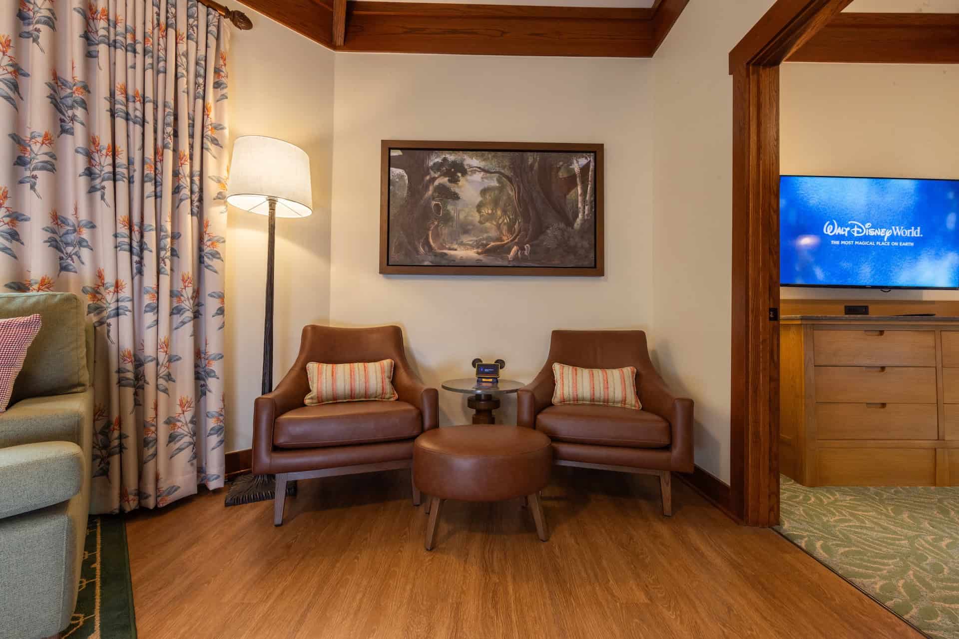 a sitting area with two chairs and a stool