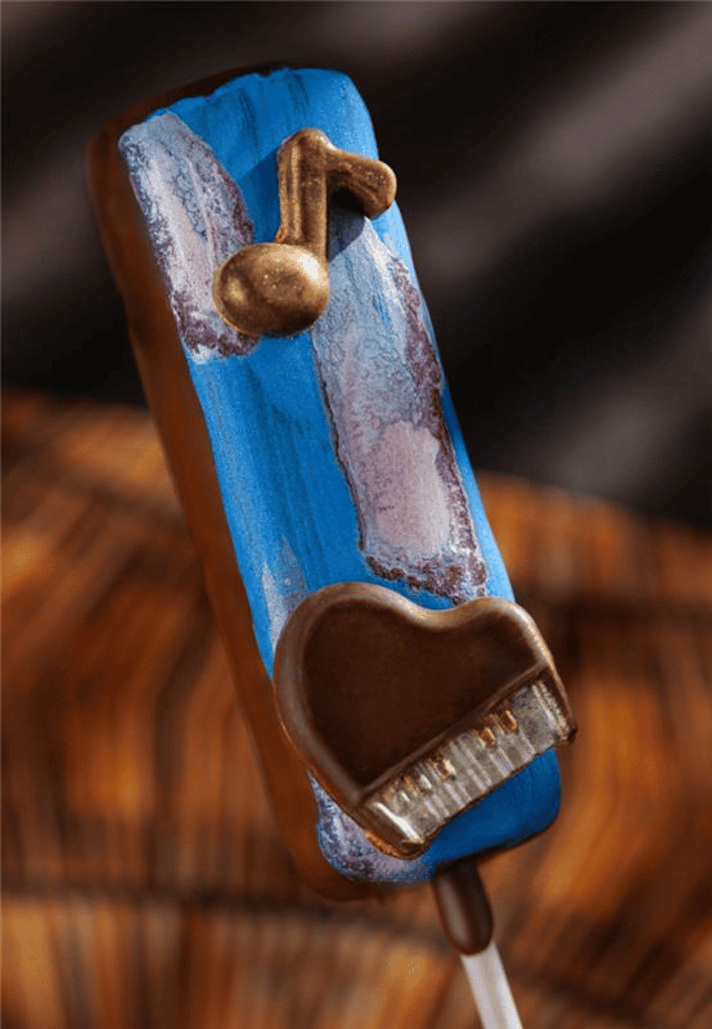 a candy pop with blue and brown colors and a heart 