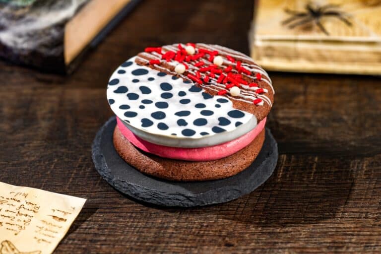 a cookie with spots, red icing, and chocolate base