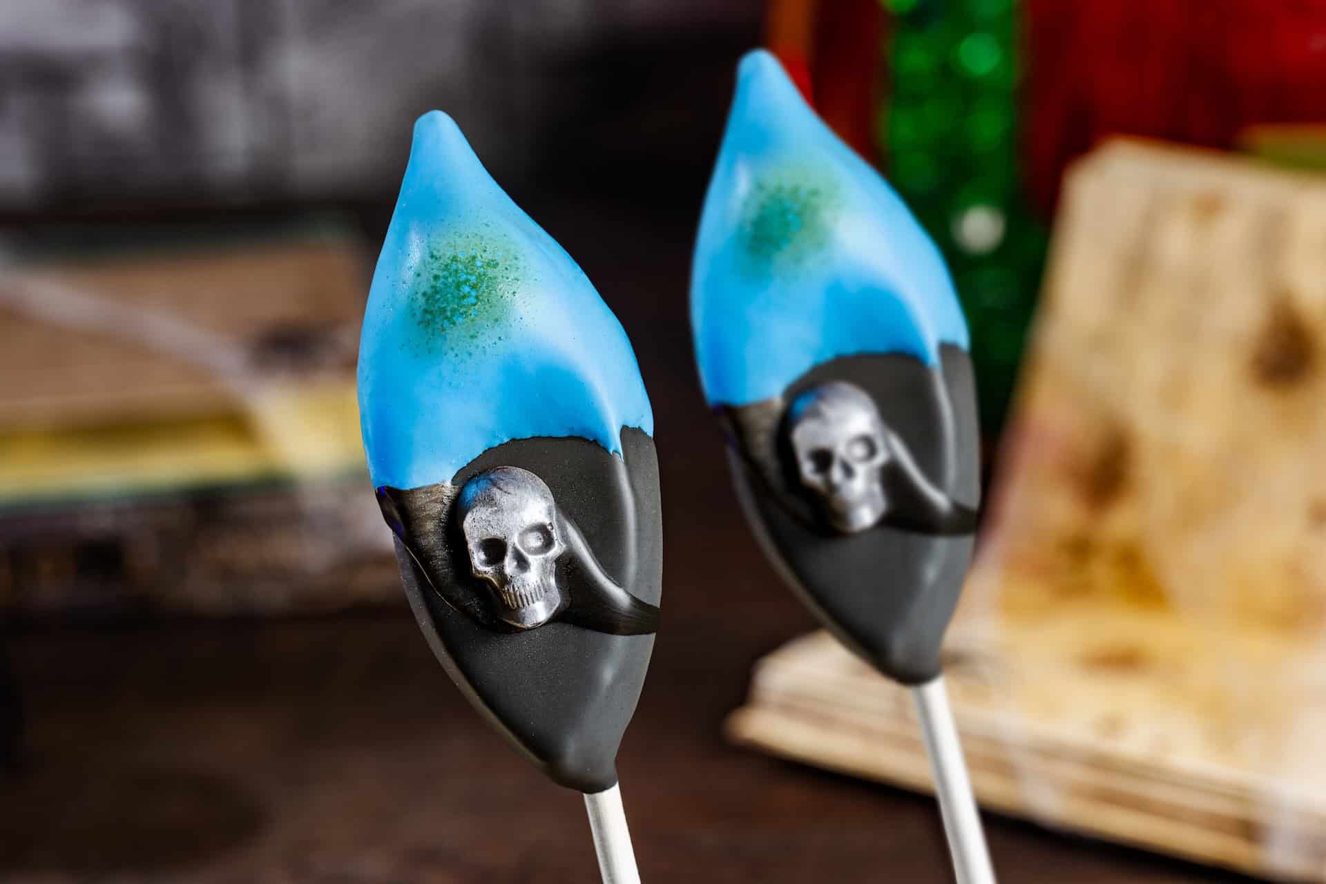 a blue and black cake pop with a skull