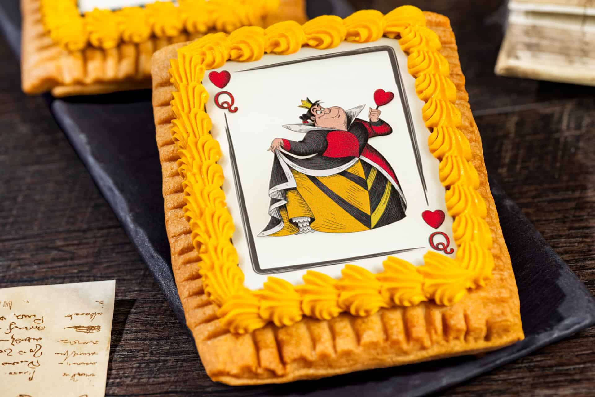 a tart with the Queen of Hearts and yellow icing 