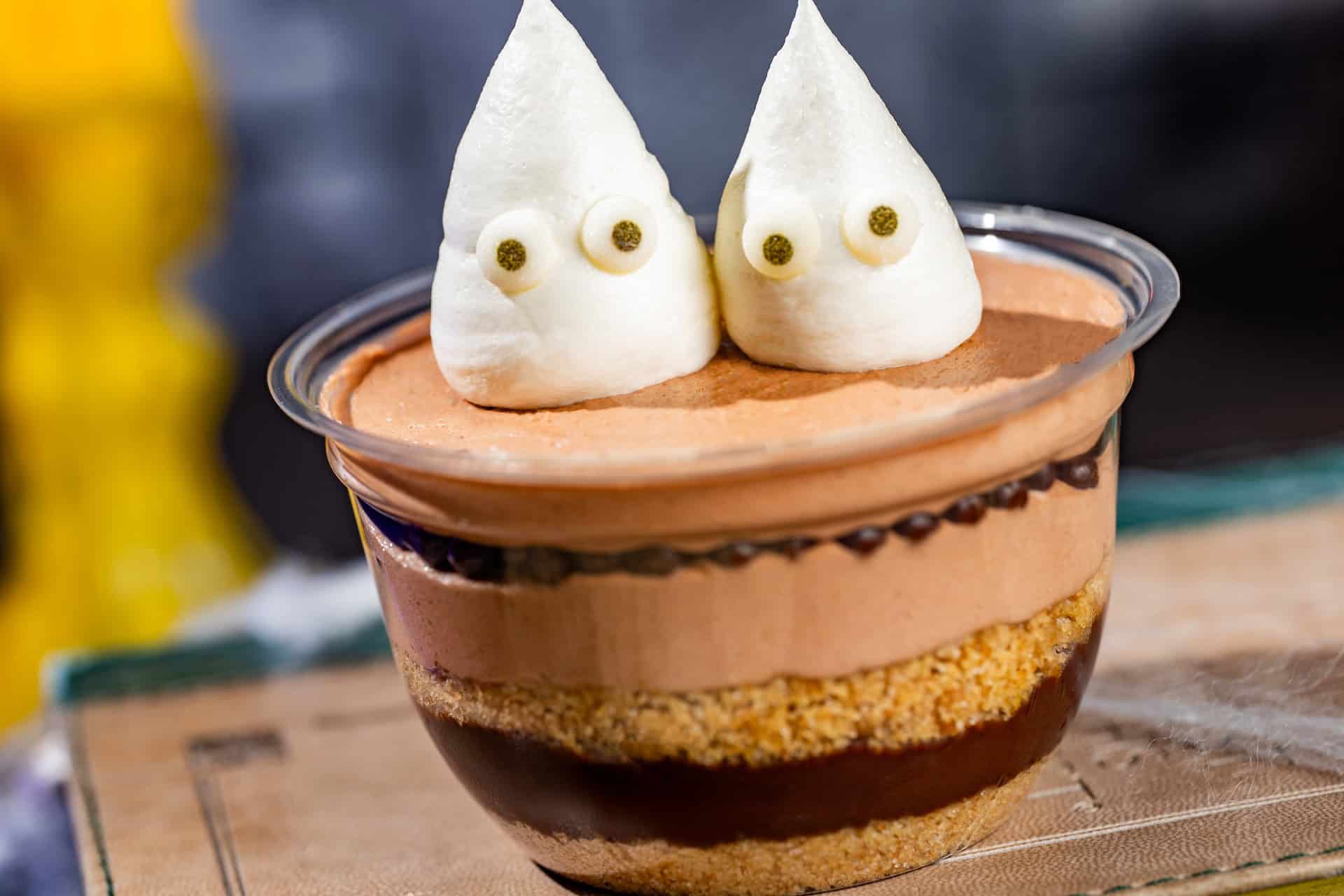 a cup of s'mores ingredient with two white dollops that look like marshmallows 