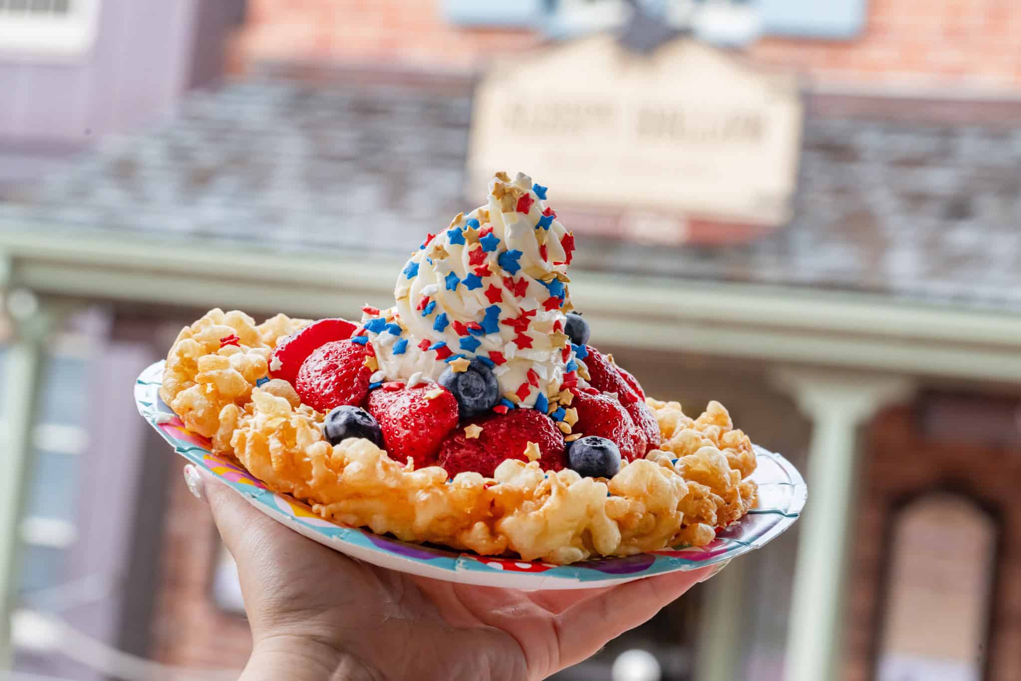 a funnel cake topped with berries and confetti stars