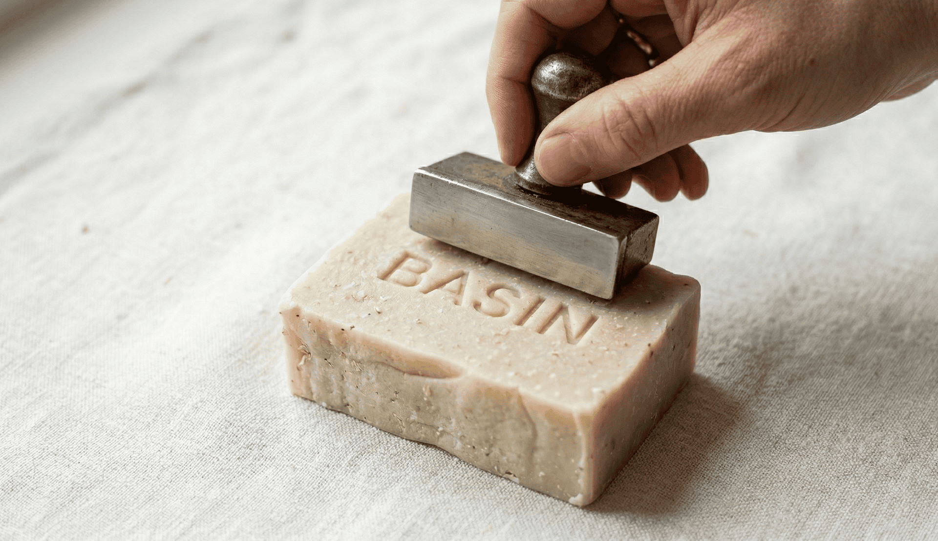 a stamp pressing Basin in a bar of soap 