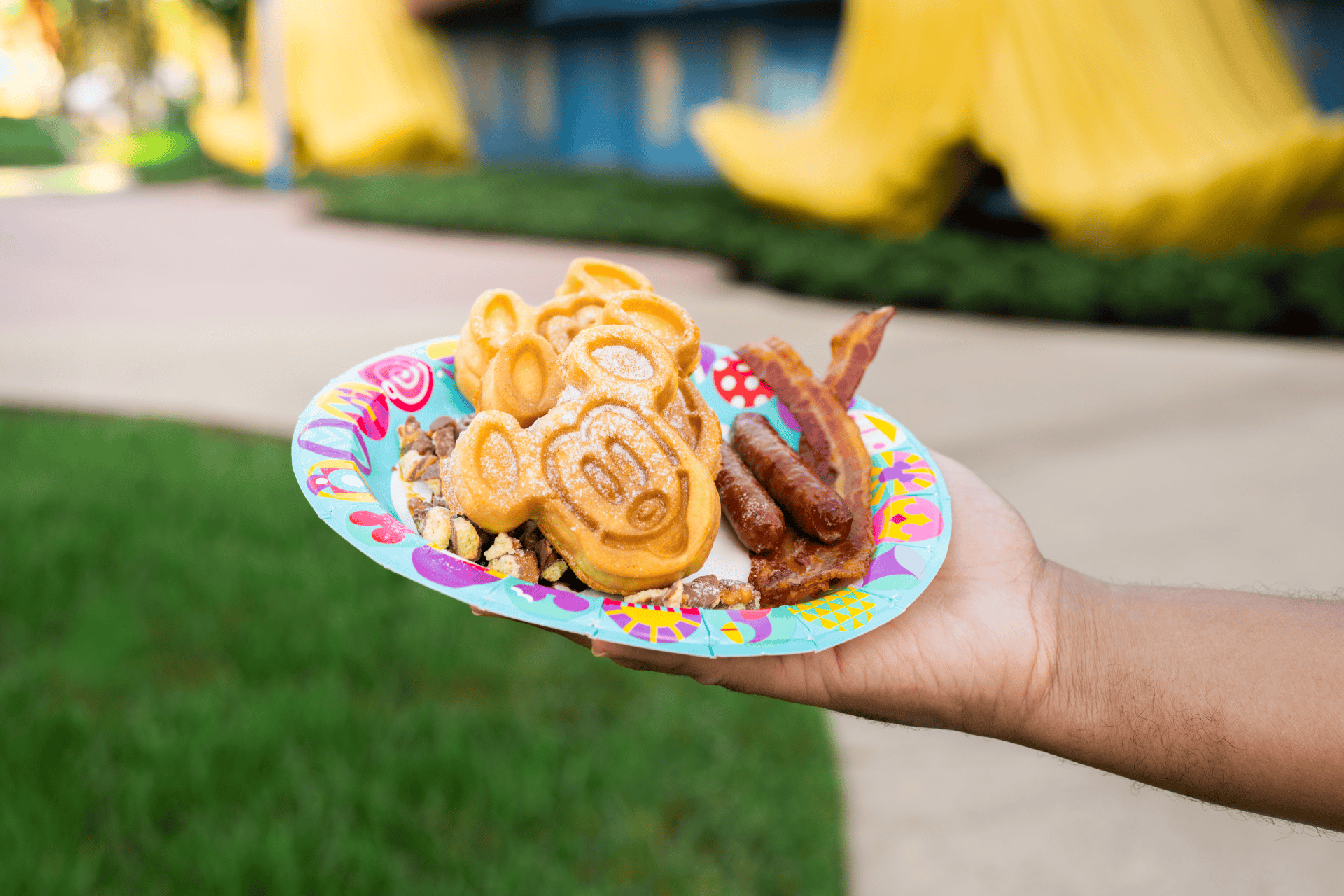 a hand holding new character waffles at Disney