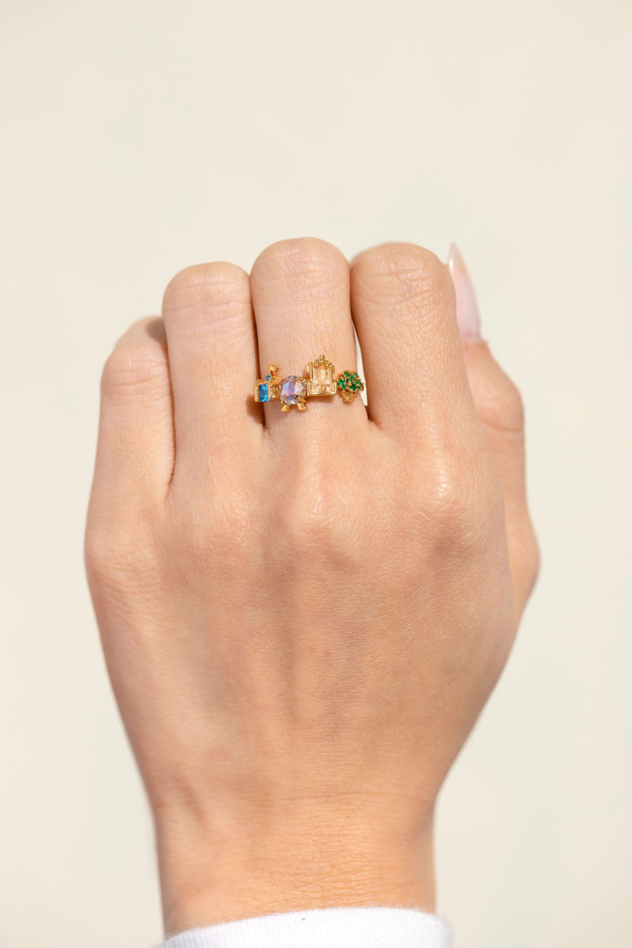 a hand modeling a ring with the four parks icons for Walt Disney World by Girls Crew 