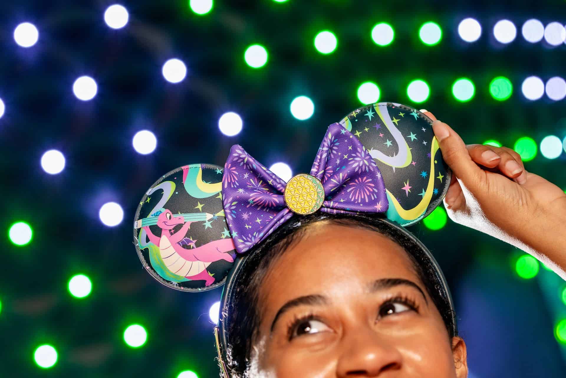 a model wearing the new Spaceship Earth and Figment inspired ears representing the 2026 Festival of the Arts 