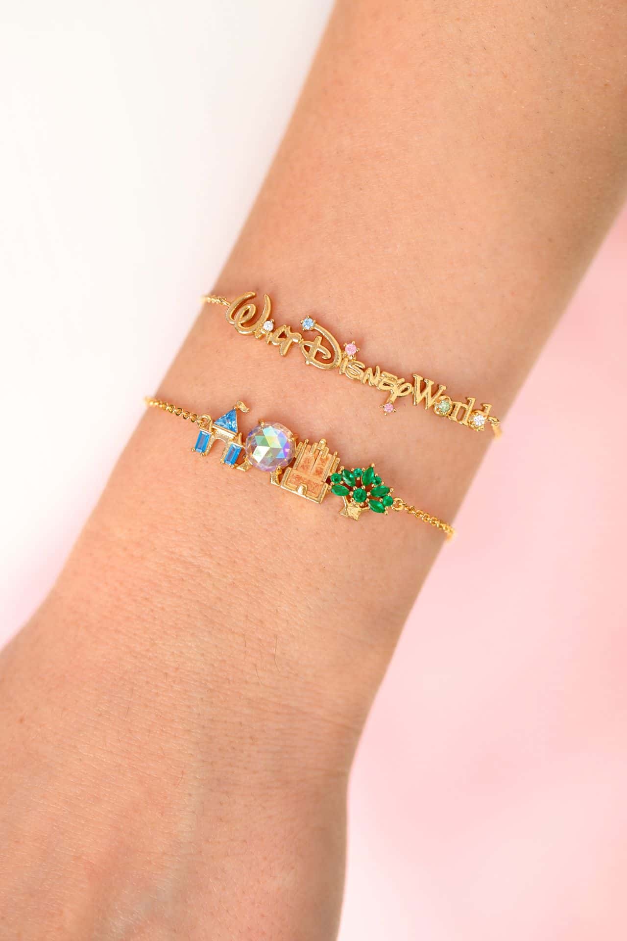 an arm modeling a Walt Disney World logo bracelet and parks icon bracelet by Girls Crew 