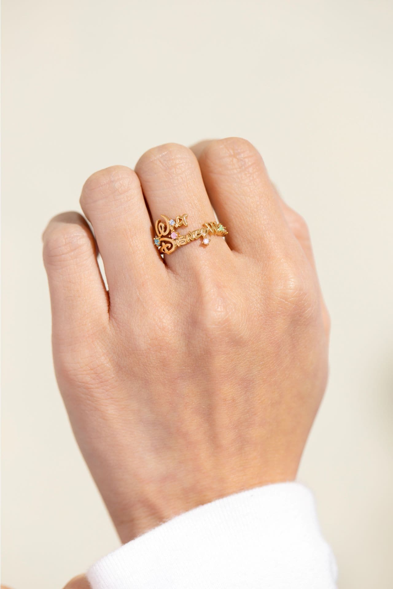 a hand modeling a ring with the Walt Disney World logo 