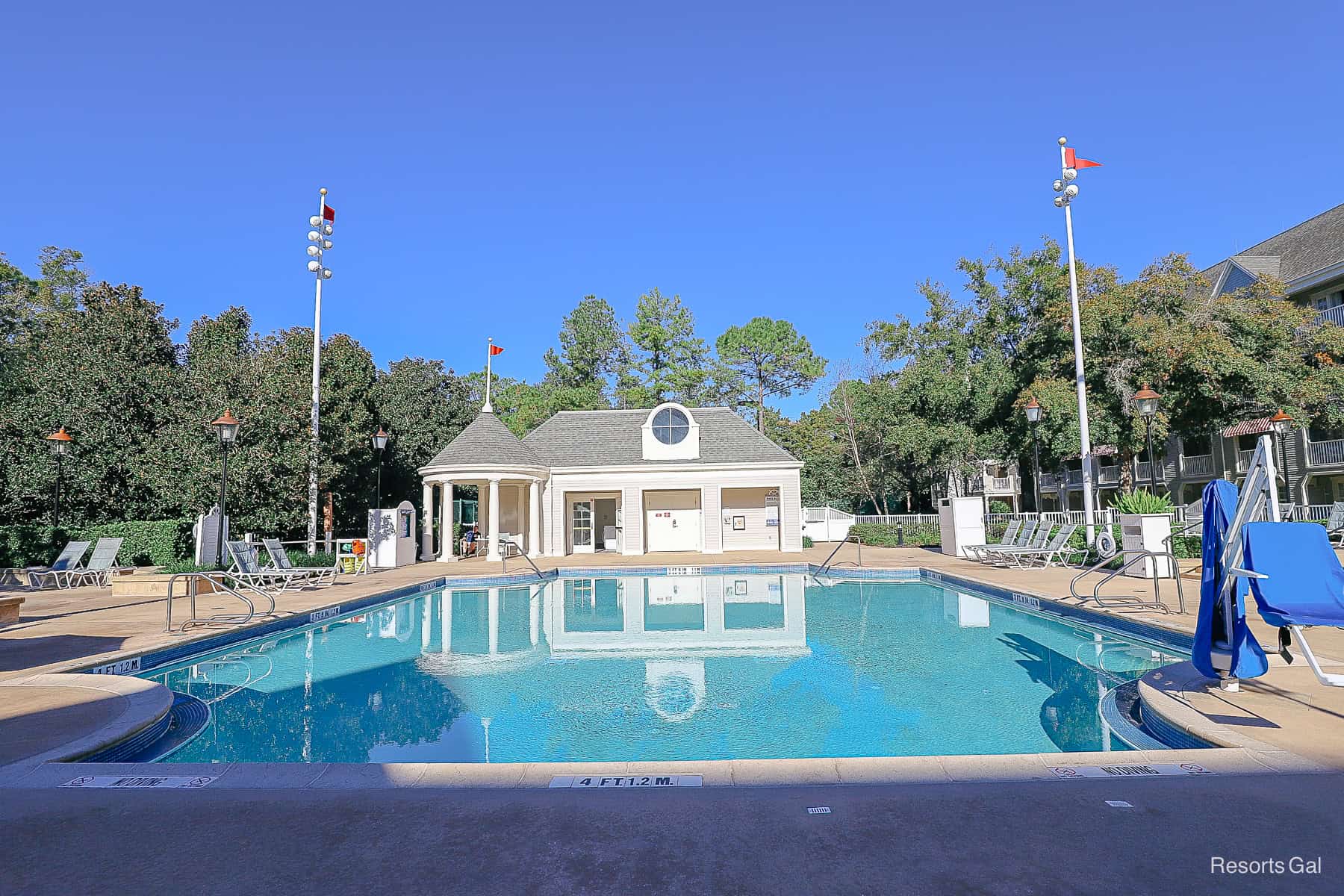 a full view of the Admiral Pool with chairs, laundry room, and mobility lift