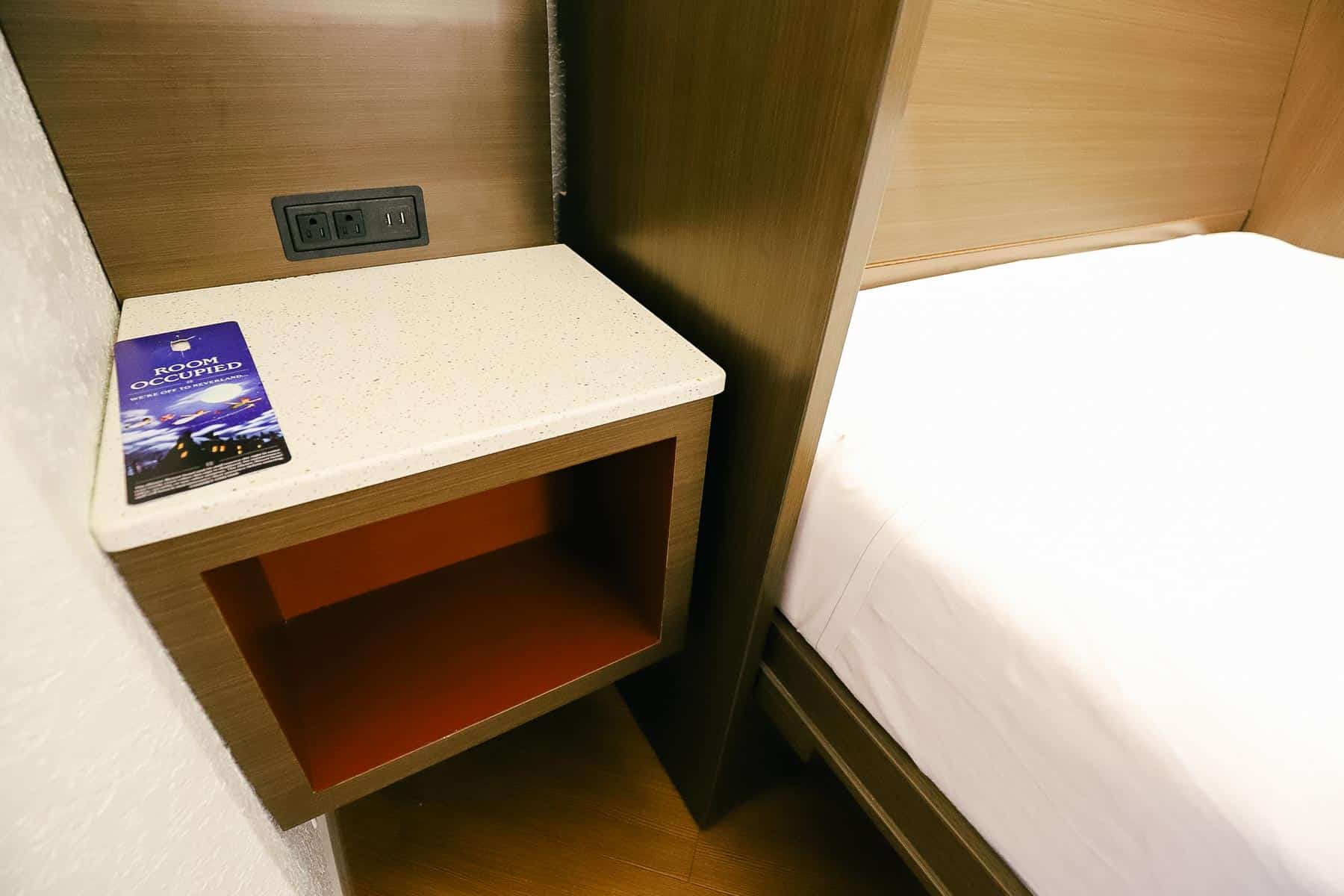 A night stand with a cubby hole beside the Murphy Bed. 