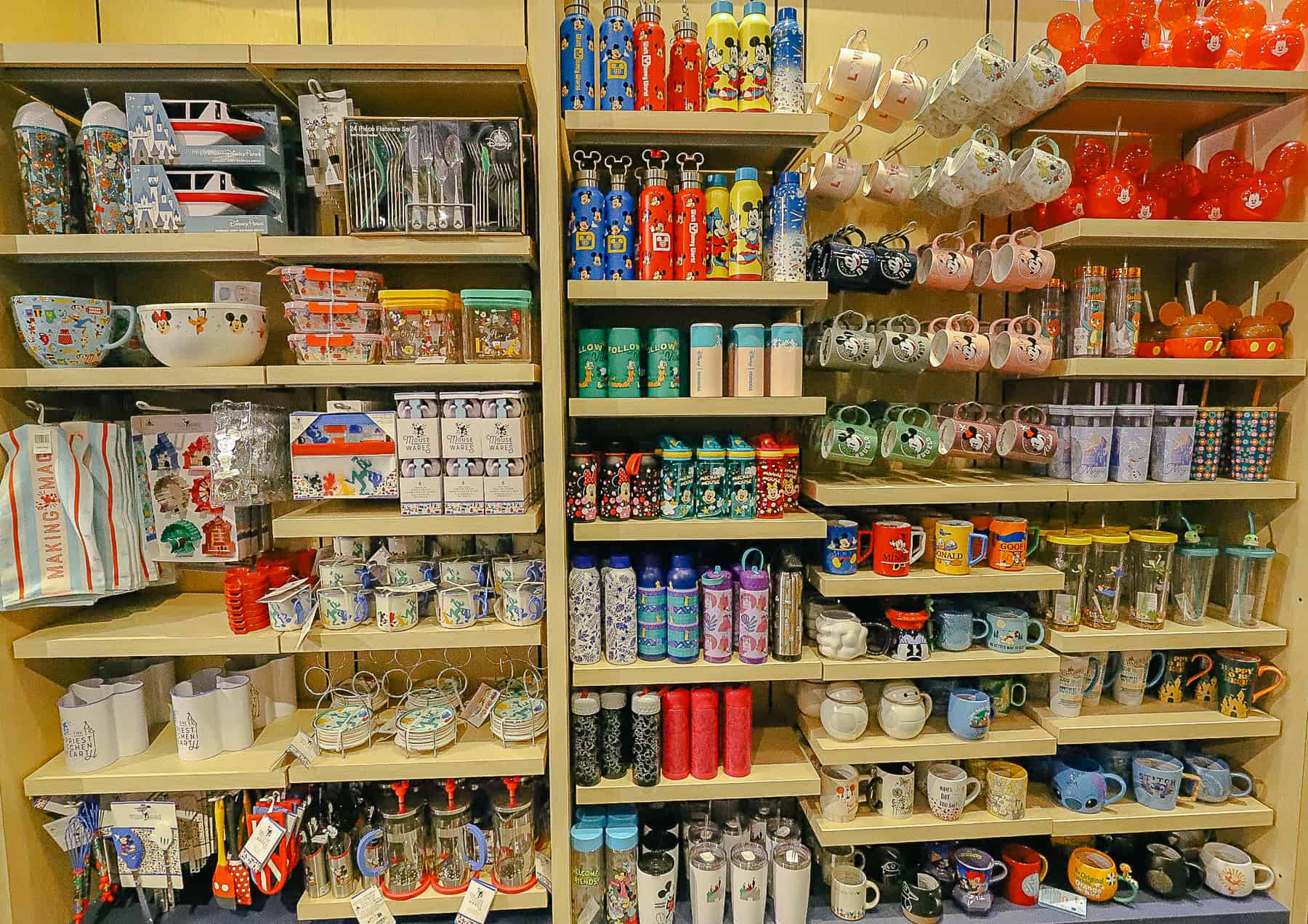 A wall with tumblers and mugs in Disney's All-Star Sports gift shop 