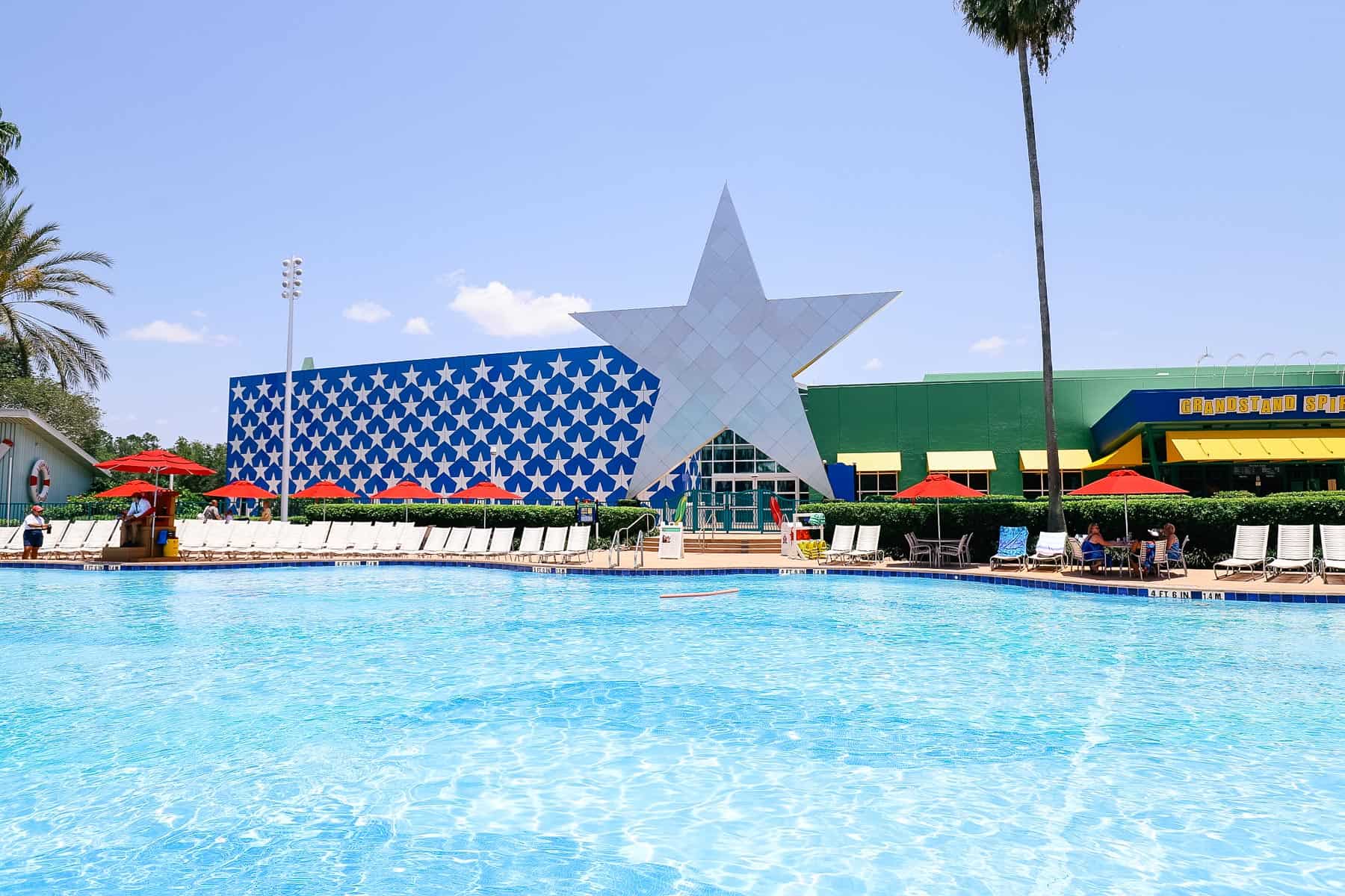 a swimming pool with a large star behind it