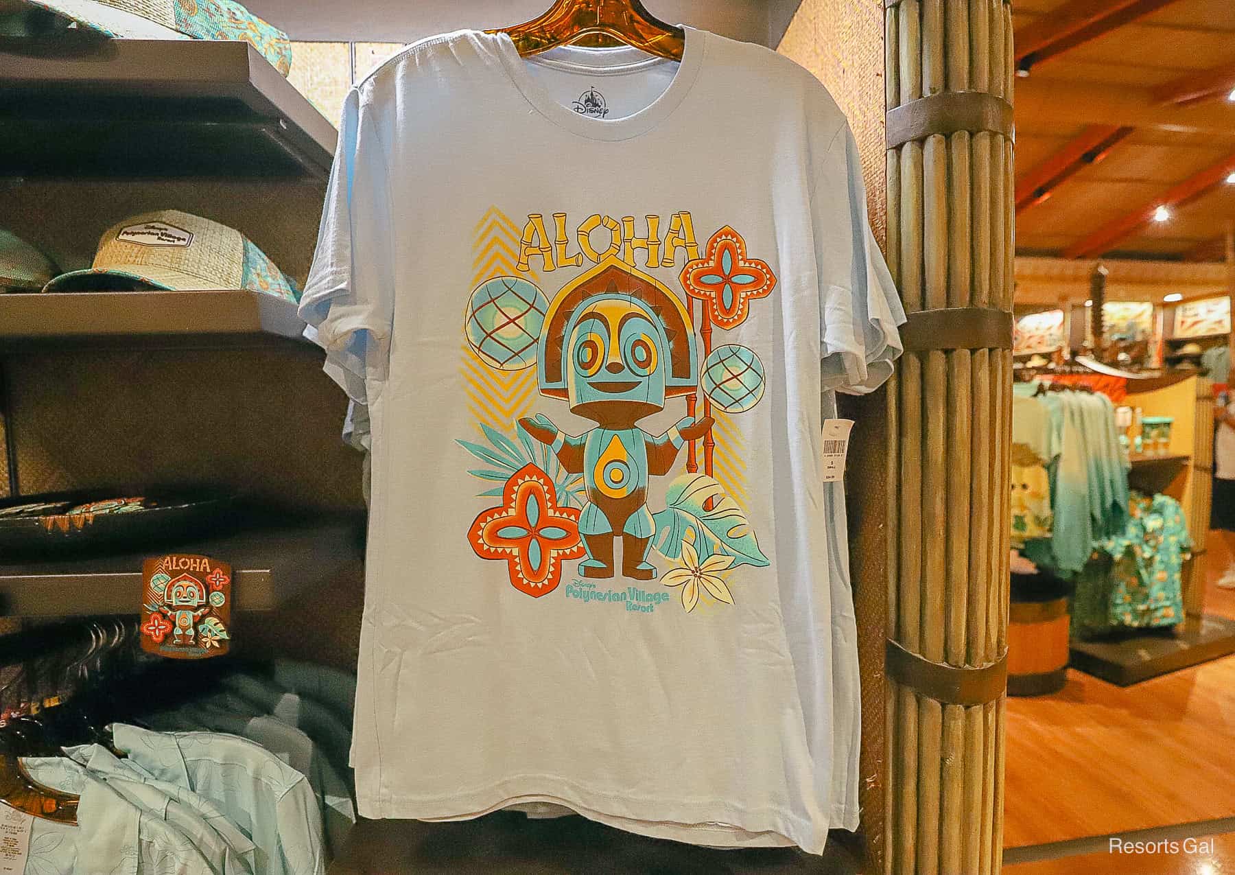 a light blue t-shirt with a tiki statue that says "Aloha, Disney's Polynesian Village Resort" 