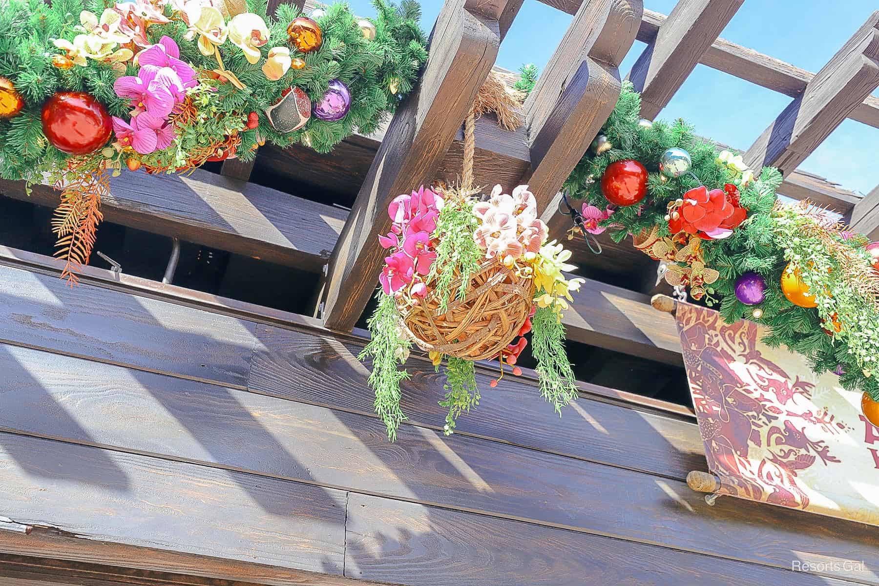 a woven ball ornament with florals in pink and yellow