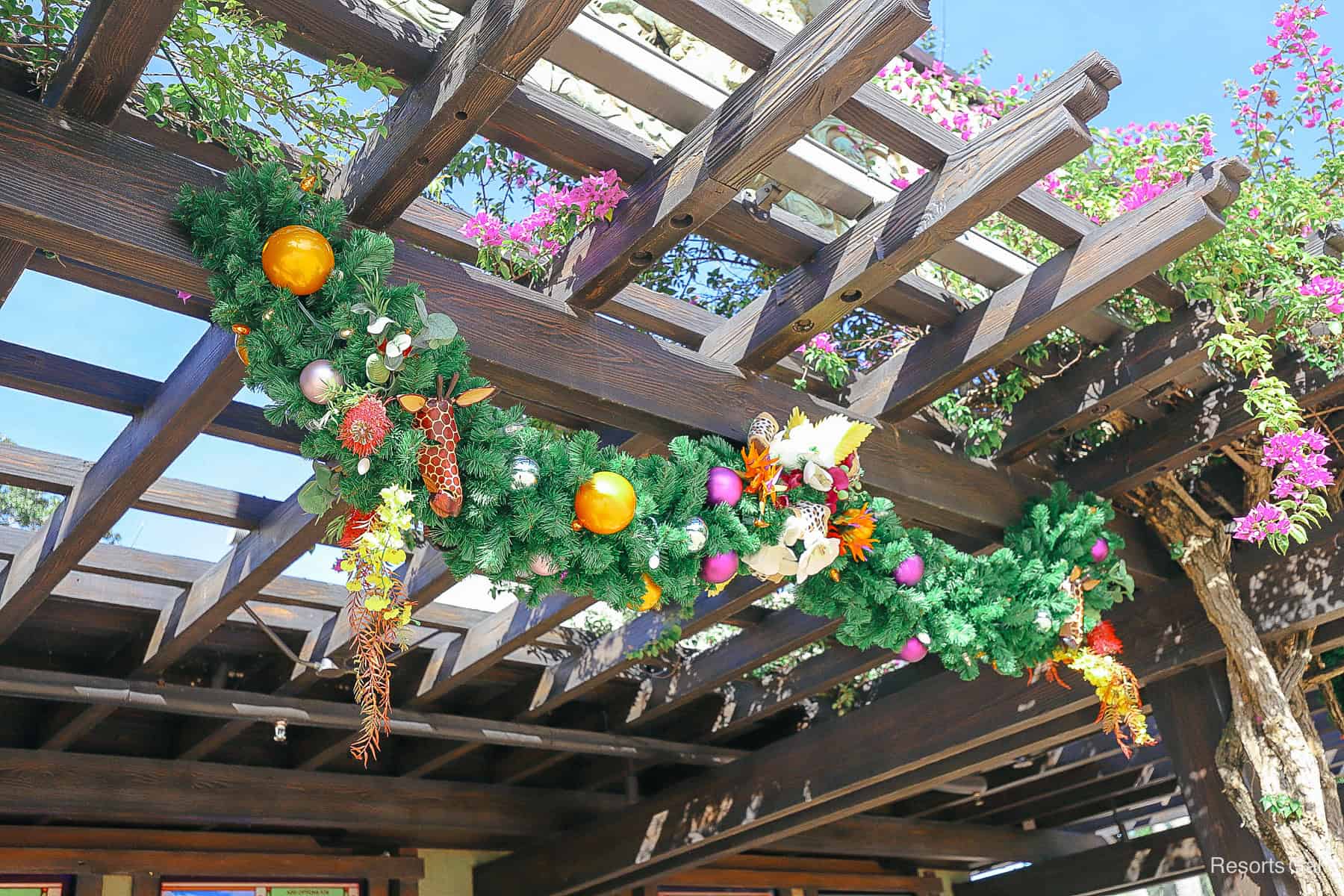 stand of garland with giraffe masks and other native holiday decorations
