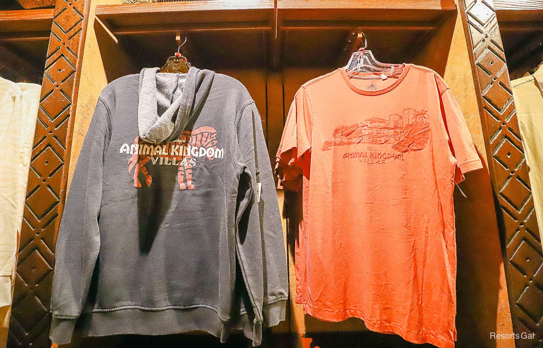 a navy blue faded zip-up jacket and a red shirt with Animal Kingdom Villas print 