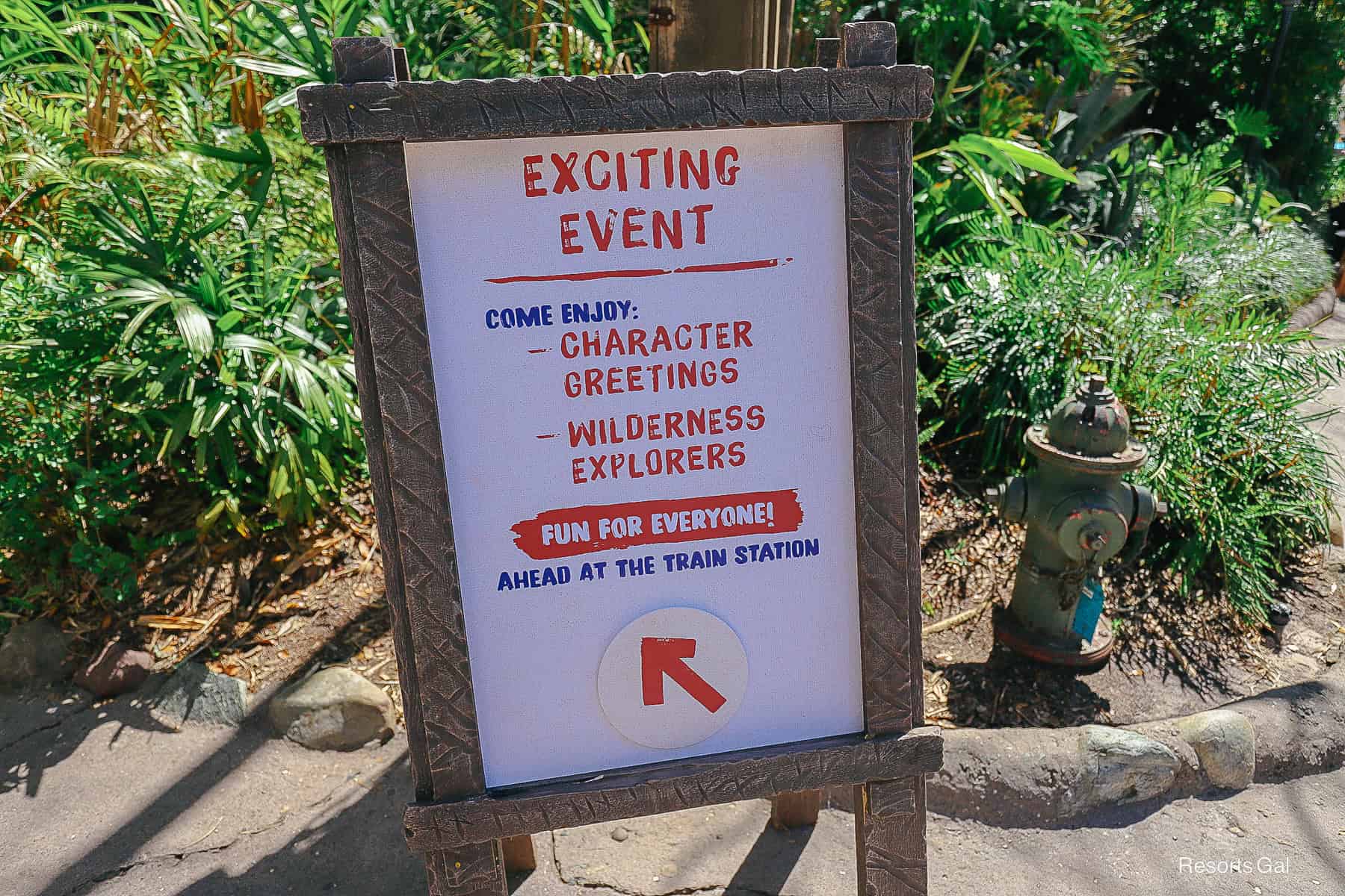 a sign pointing guests to special character greetings at the Harambe Train Station 