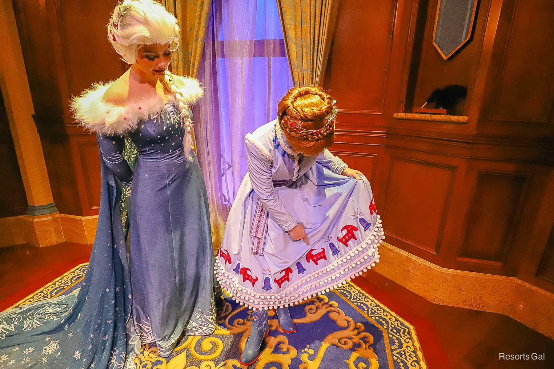 Anna pointing to the Yule Bell on her dress. 