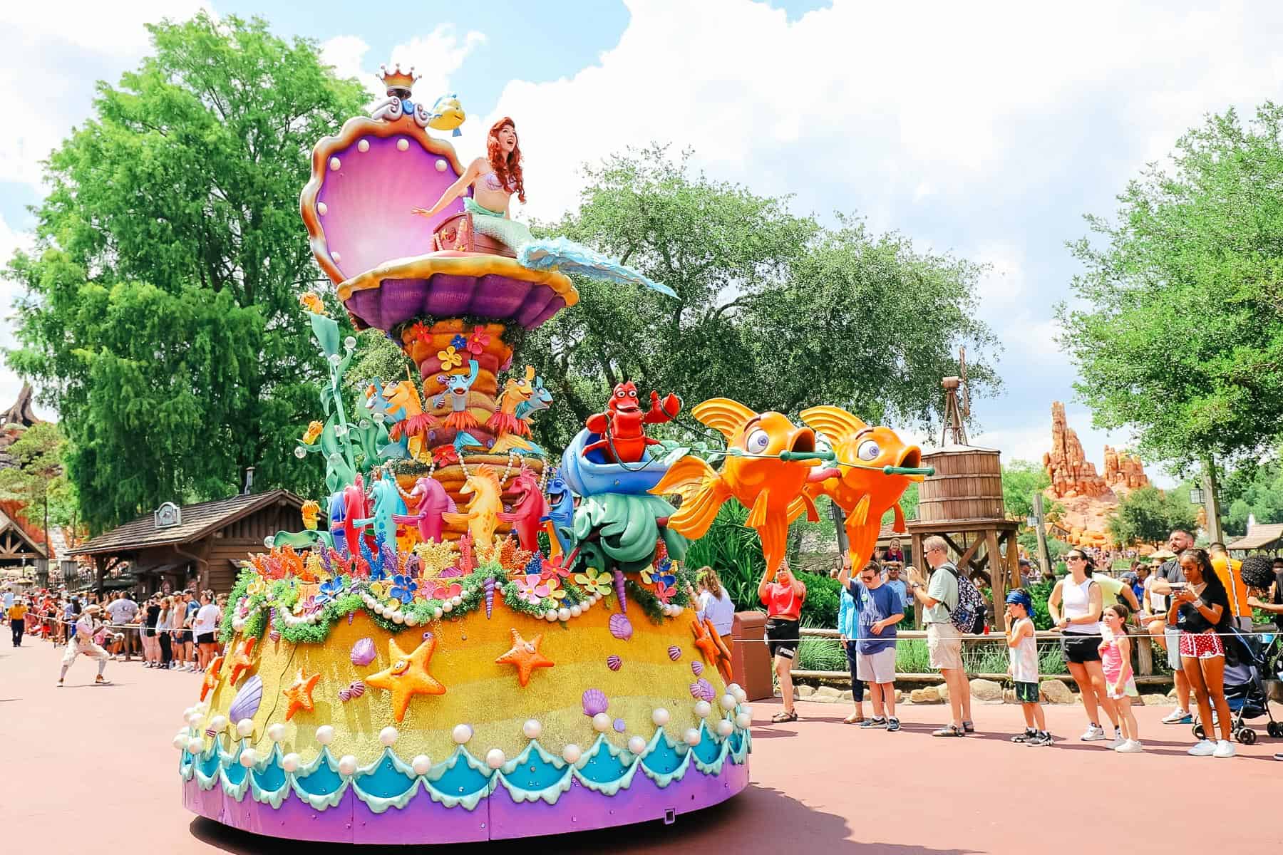 Ariel rides on top of The Little Mermaid float at Magic Kingdom. 