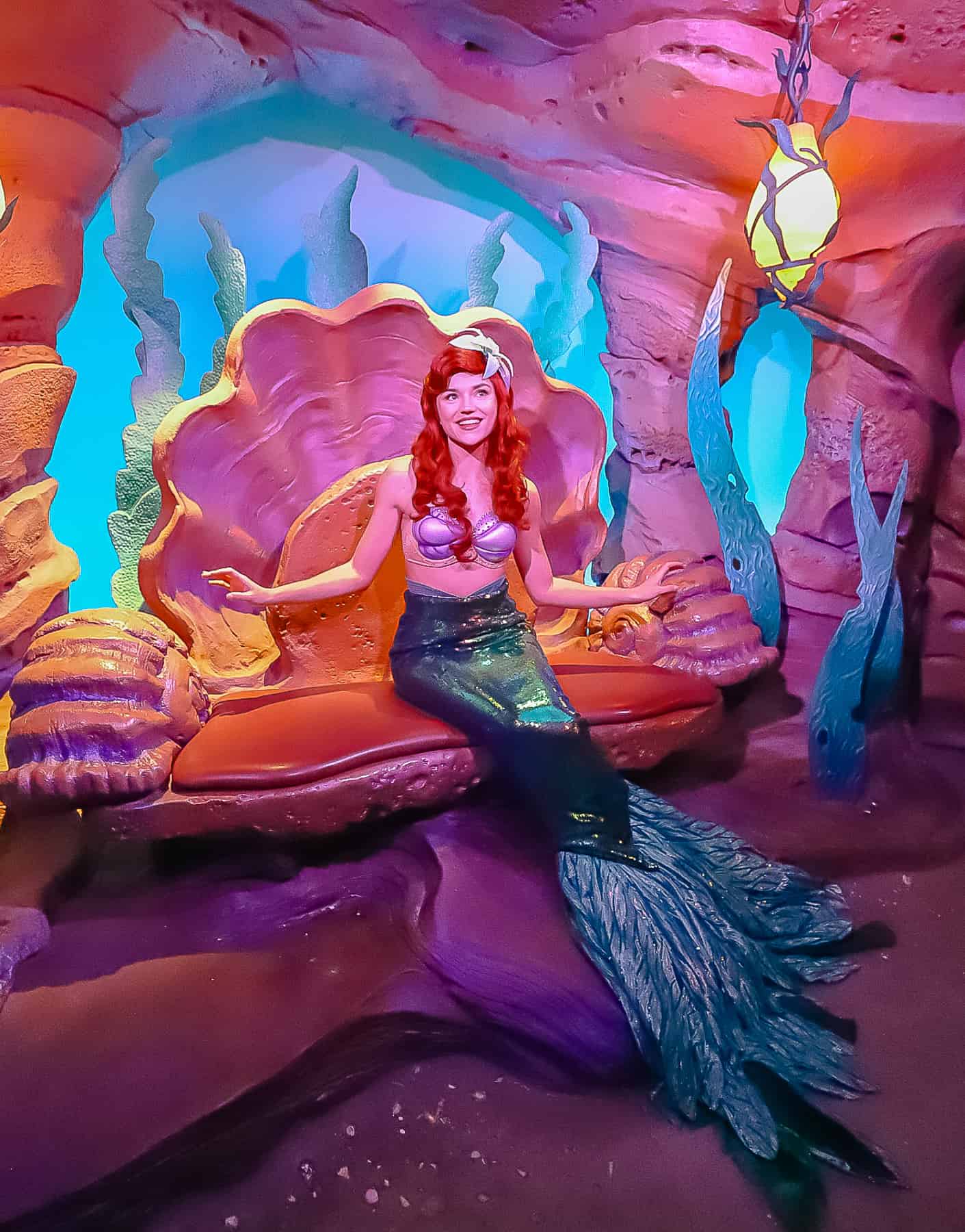 full shot of Ariel in her mermaid costume with fins 