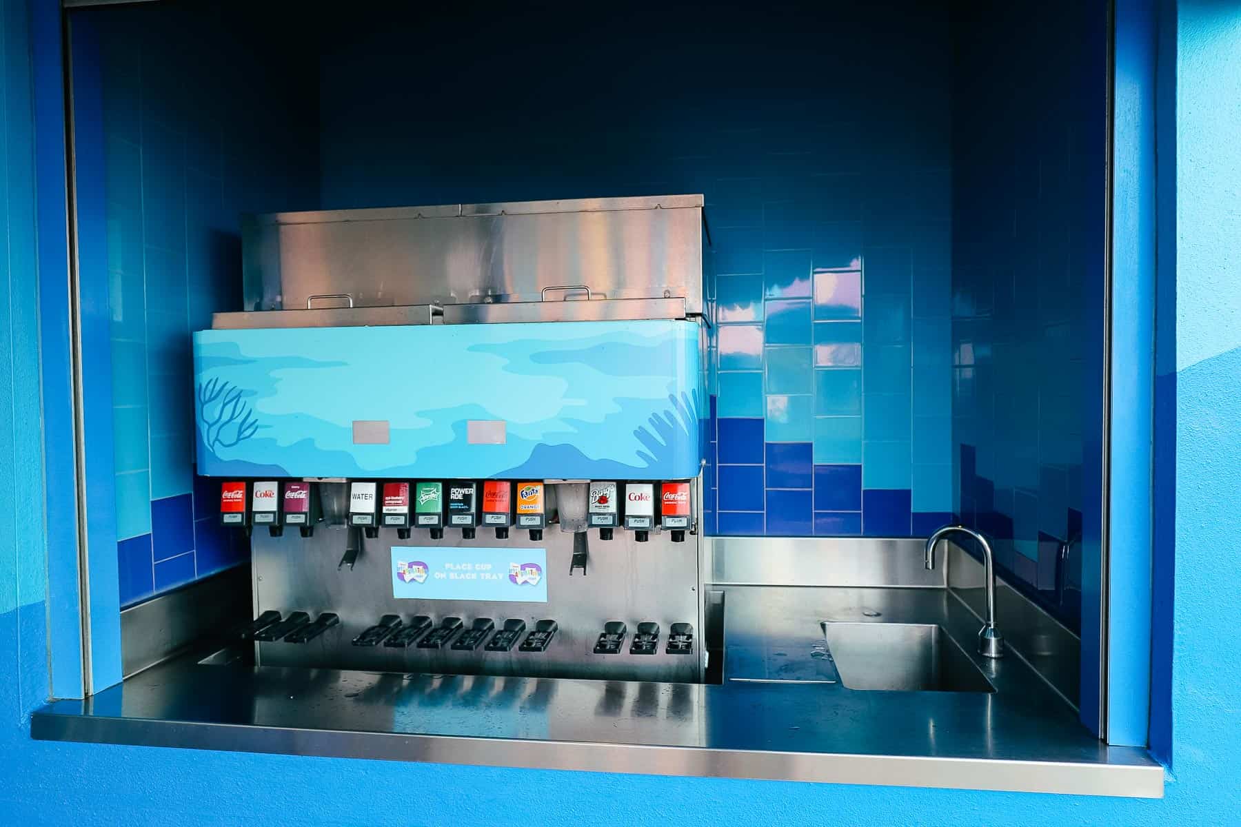 a refillable beverage machine by The Big Blue Pool at Art of Animation 
