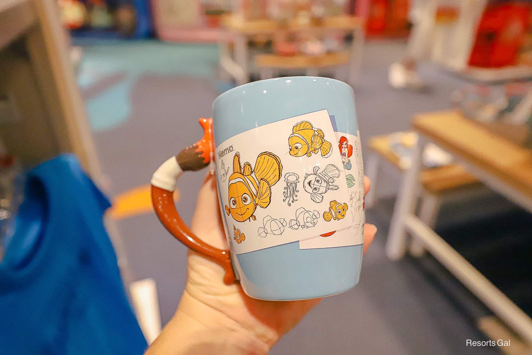 front side of the coffee mug with Finding Nemo and The Little Mermaid 