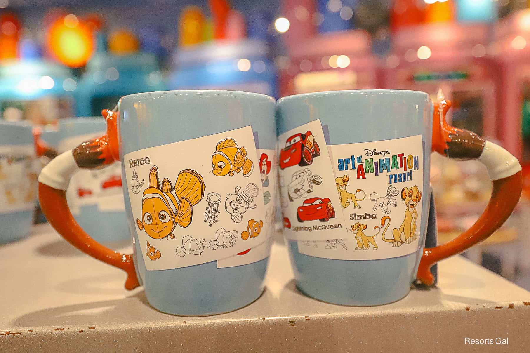 a blue coffee mug with a paintbrush handle 