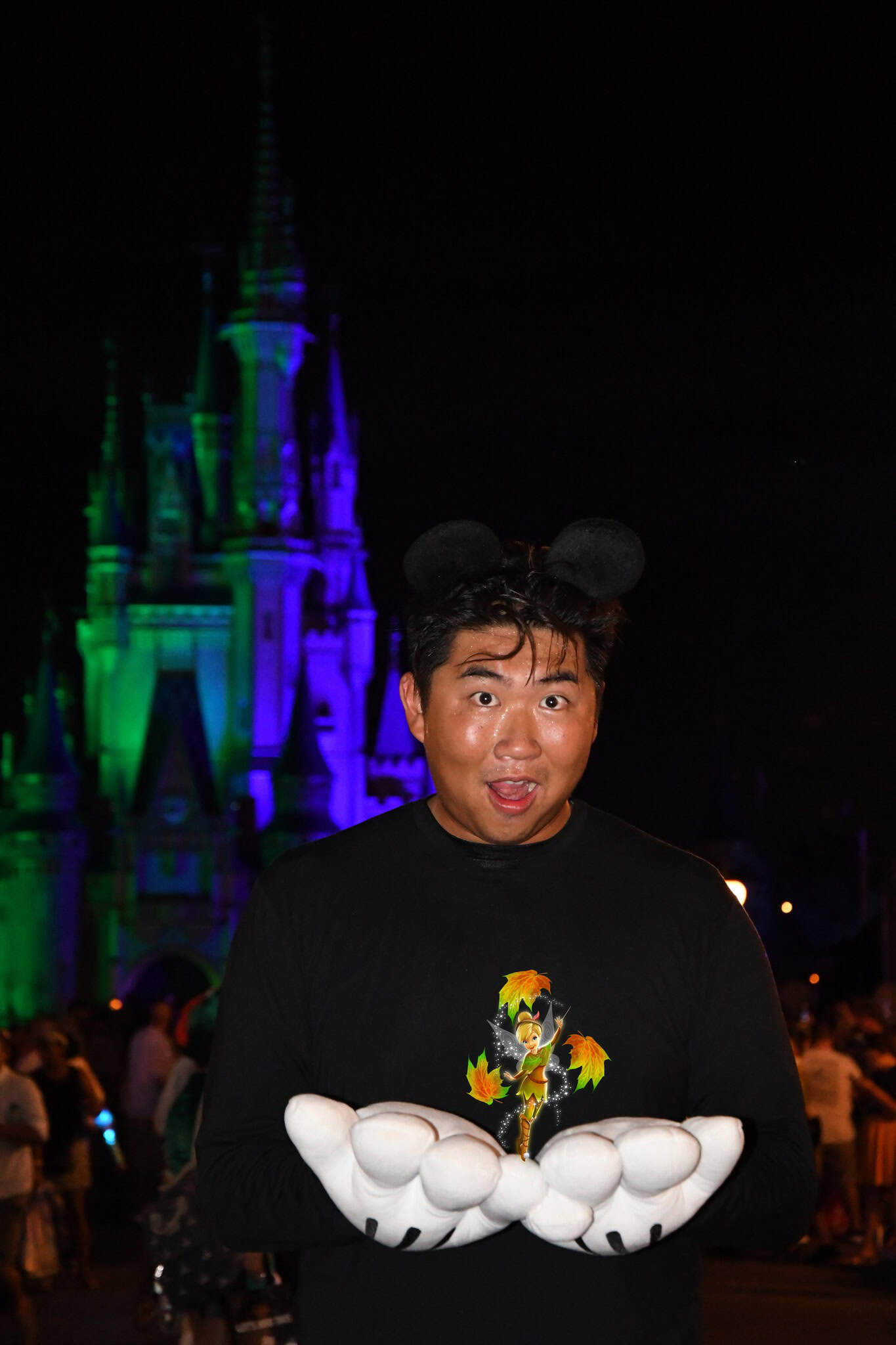 a guest holding a tiny Autumn Tinker Bell in his hands  by magic shot 