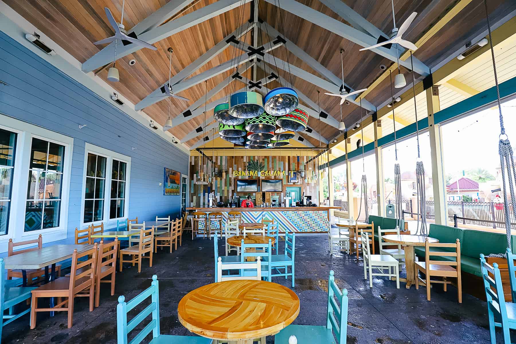 seating area with tables and chairs at Banana Cabana near the pool