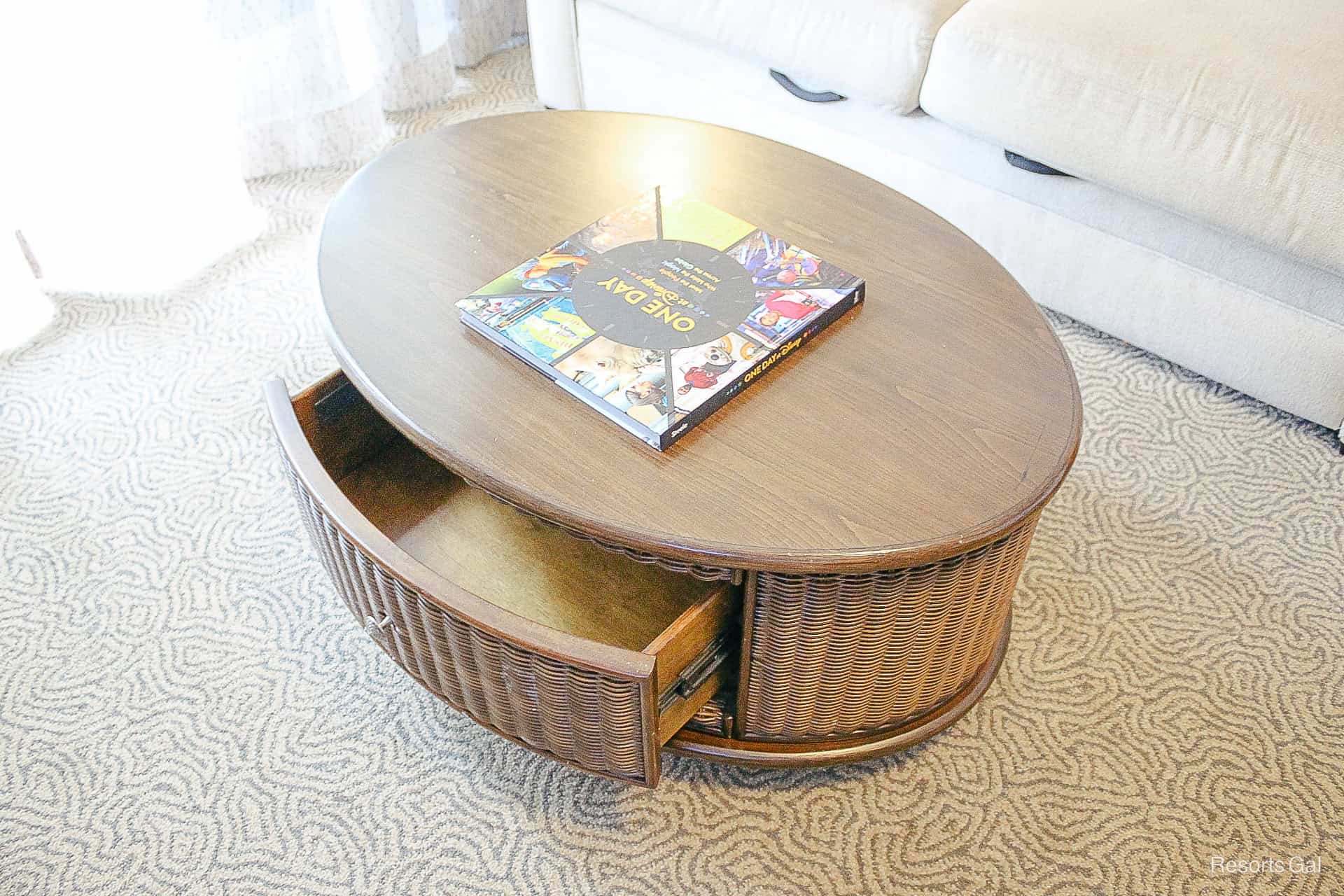 a coffee table with a drawer revealing storage 