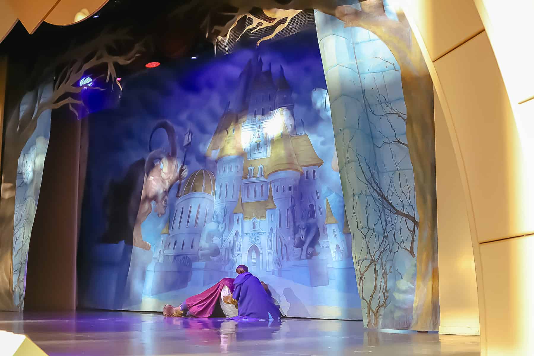 Belle rushes to Beast's side. 