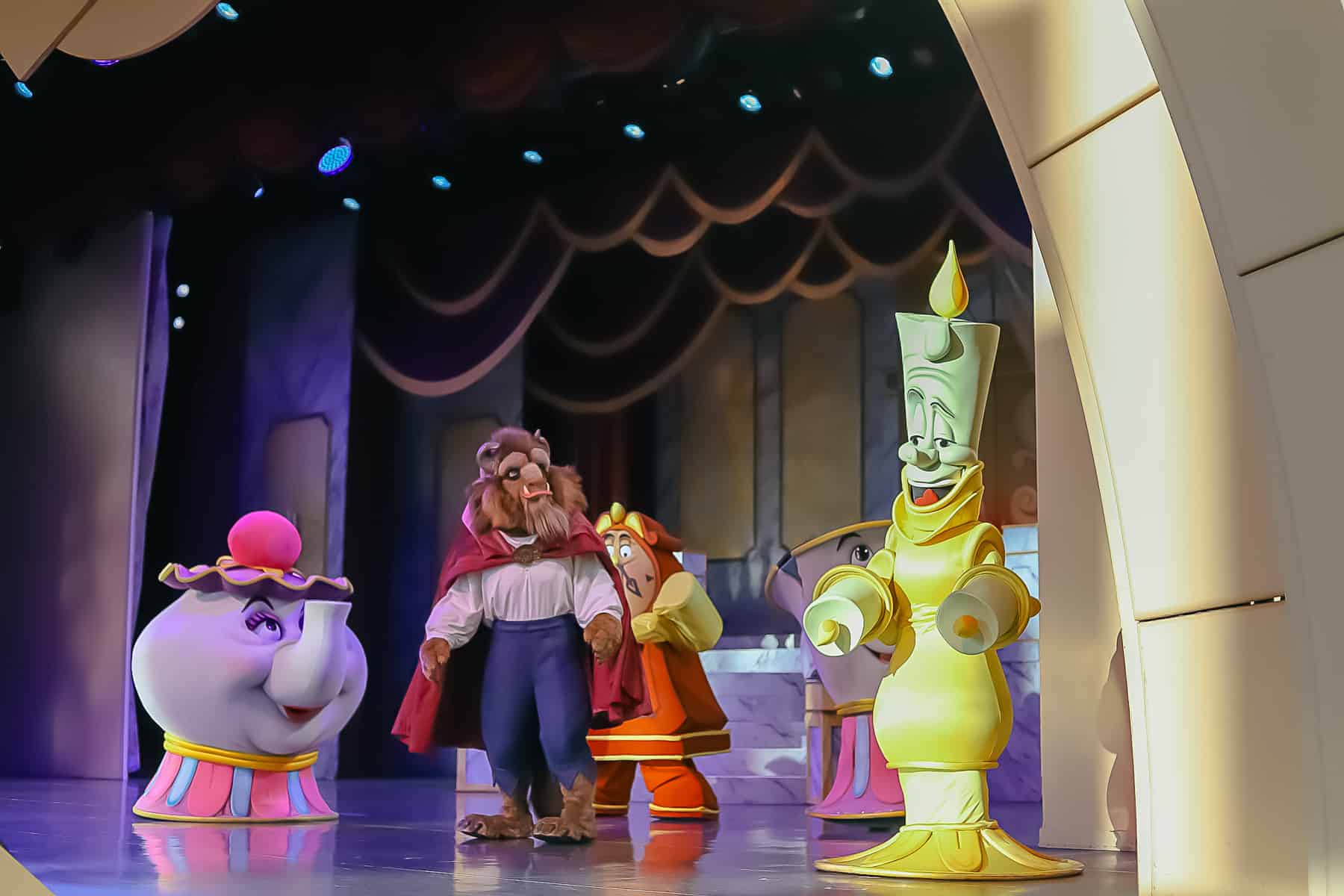 Beast on stage with Mrs. Potts and Lumiere 