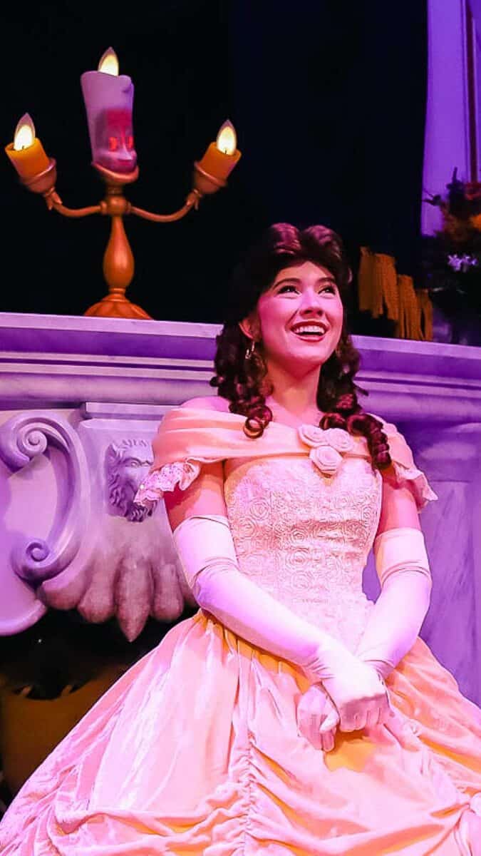 Belle smiles wearing her yellow ball gown. 