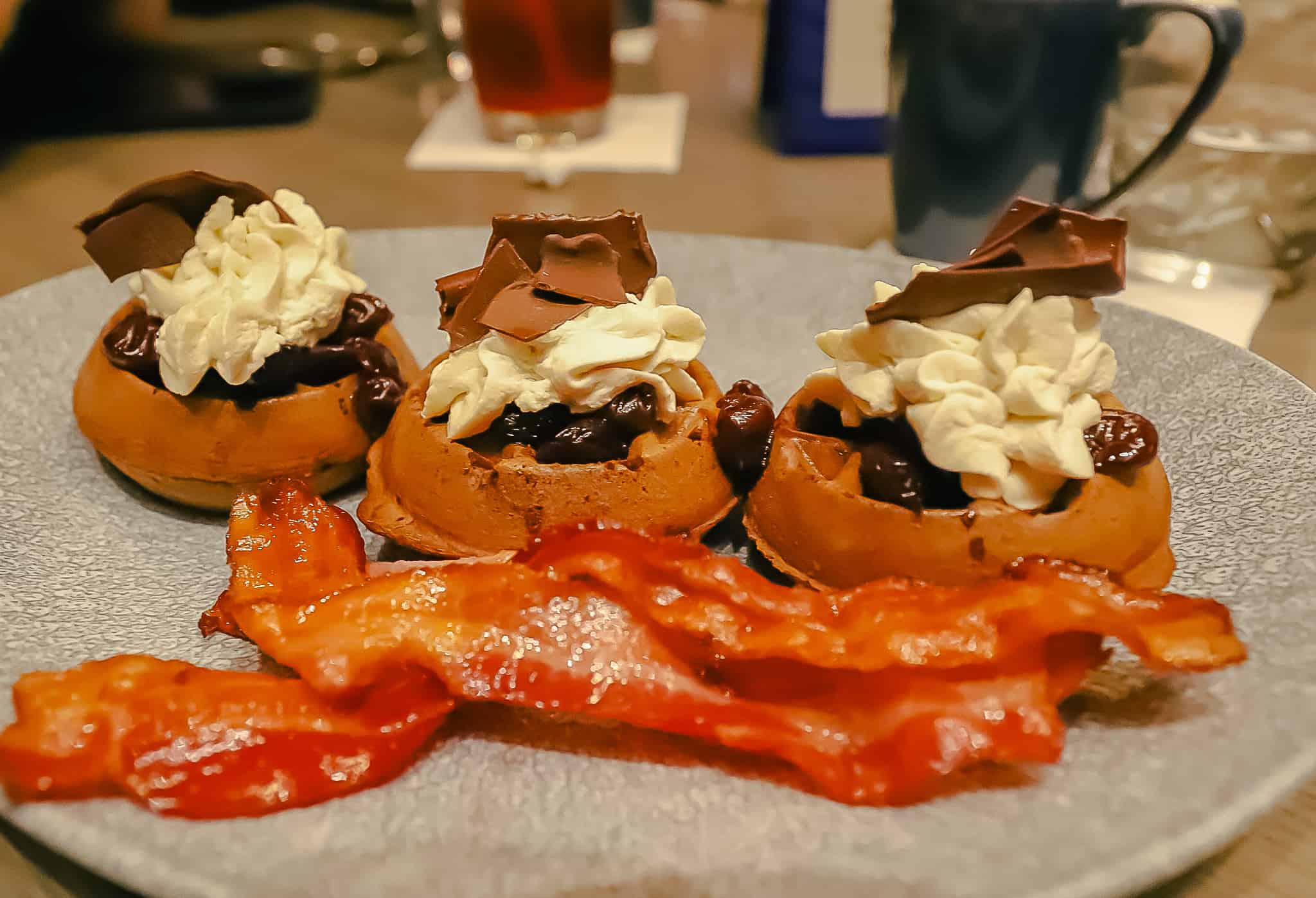 bacon and waffles with whip cream and chocolate shavings 