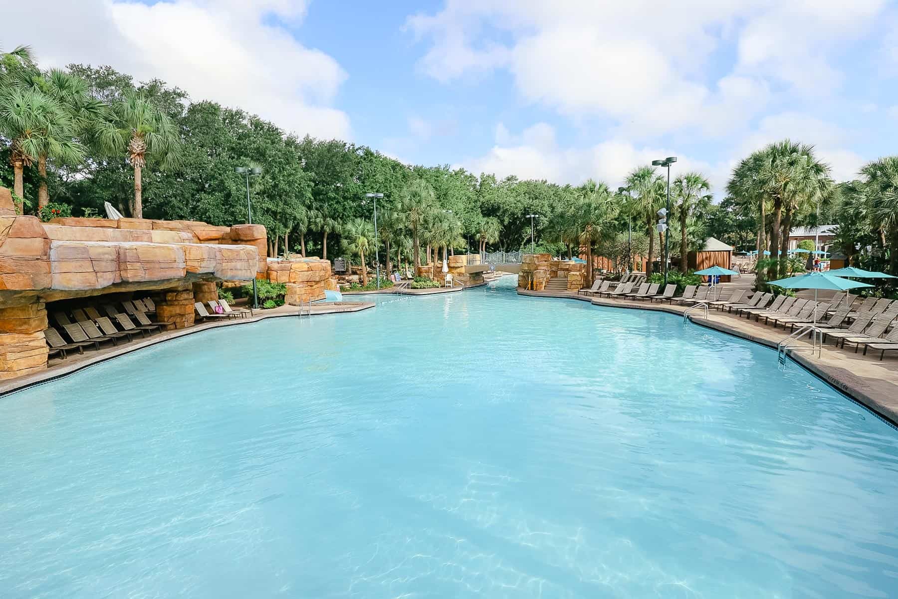 chairs sitting under the grotto area at the pool 