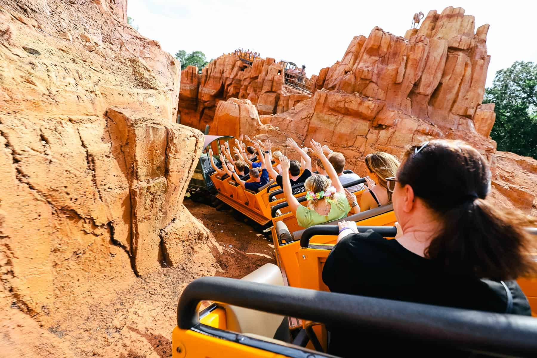 Guests flying around the first curve with their hands up. 