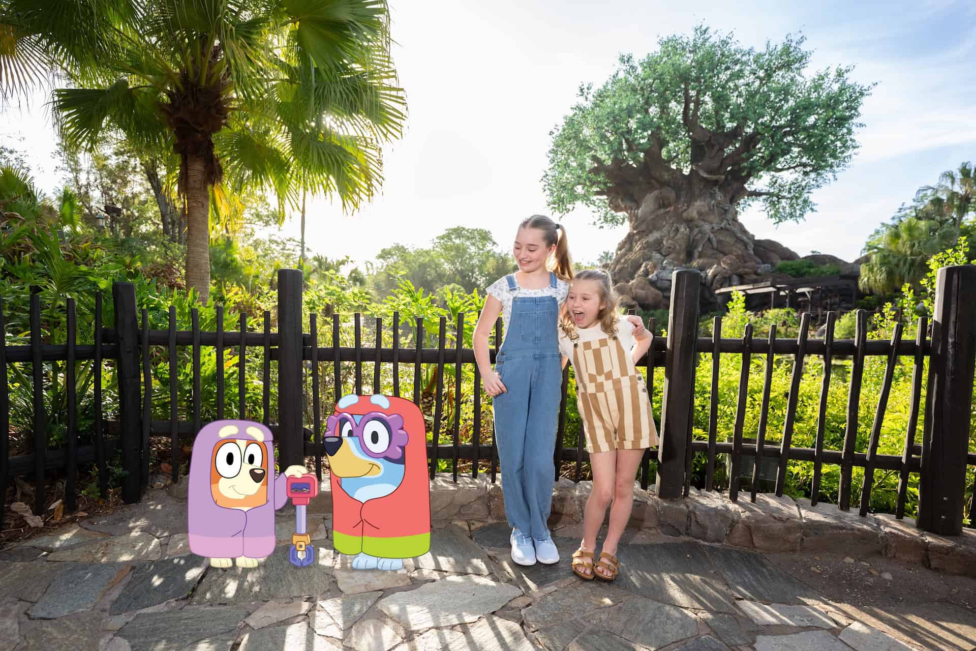 two sisters posing with Bluey and Bingo Magic Shot 
