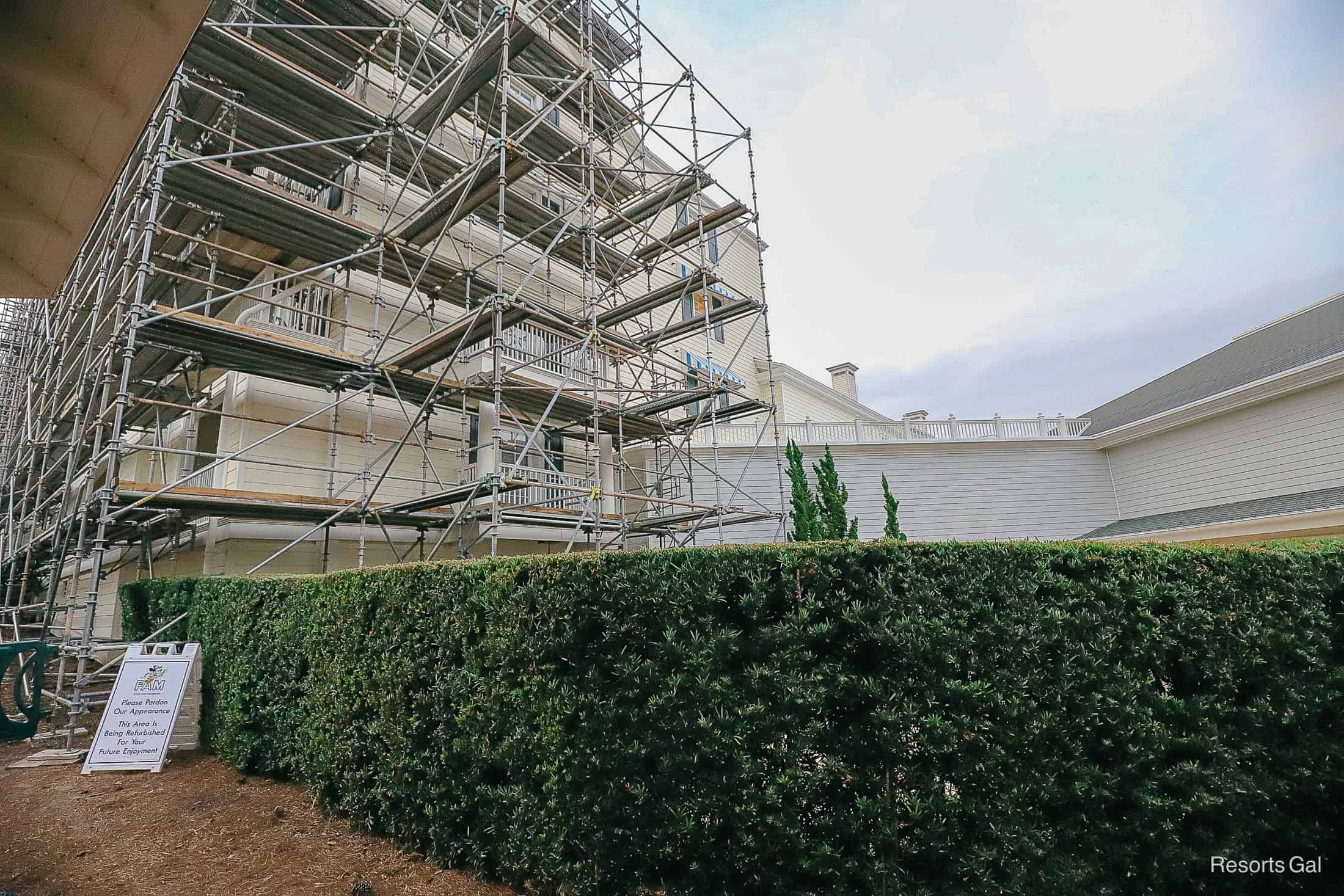 scaffolding and an area where the paint color changes from grey to cream 