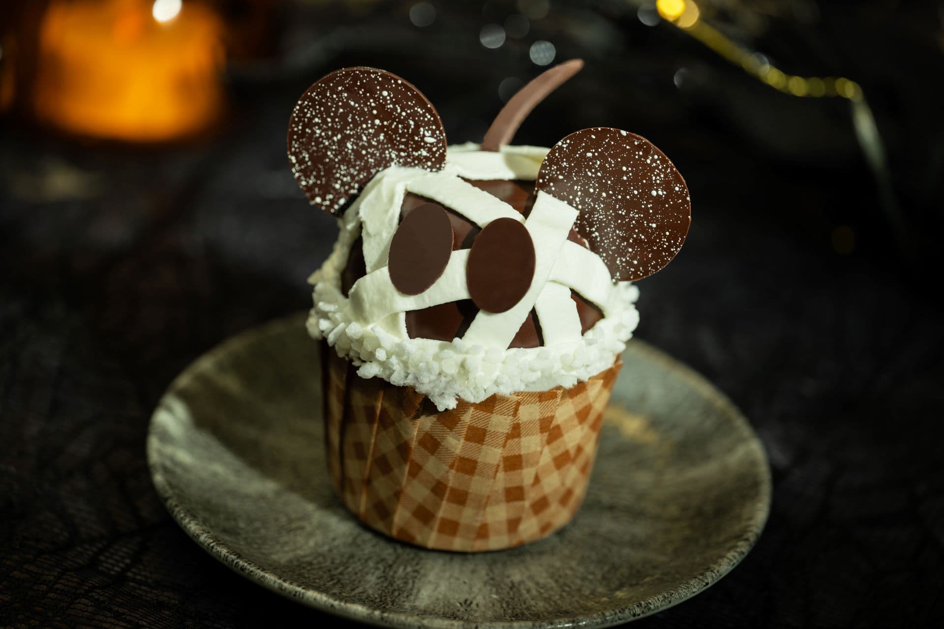 a cupcake with Mickey ears designed to look like a mummy