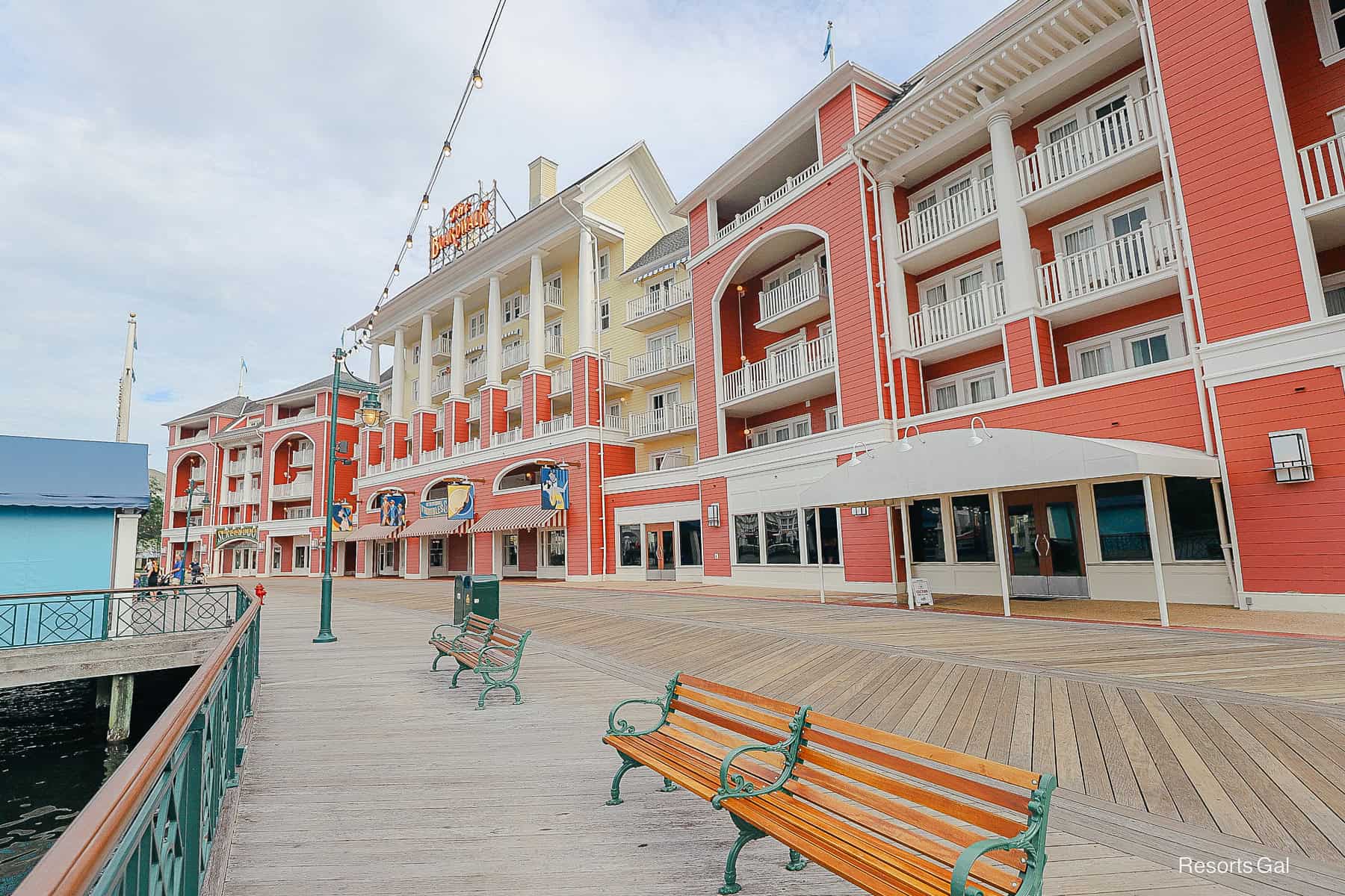 a bench sitting in front of The Boardwalk sign at Disney World 