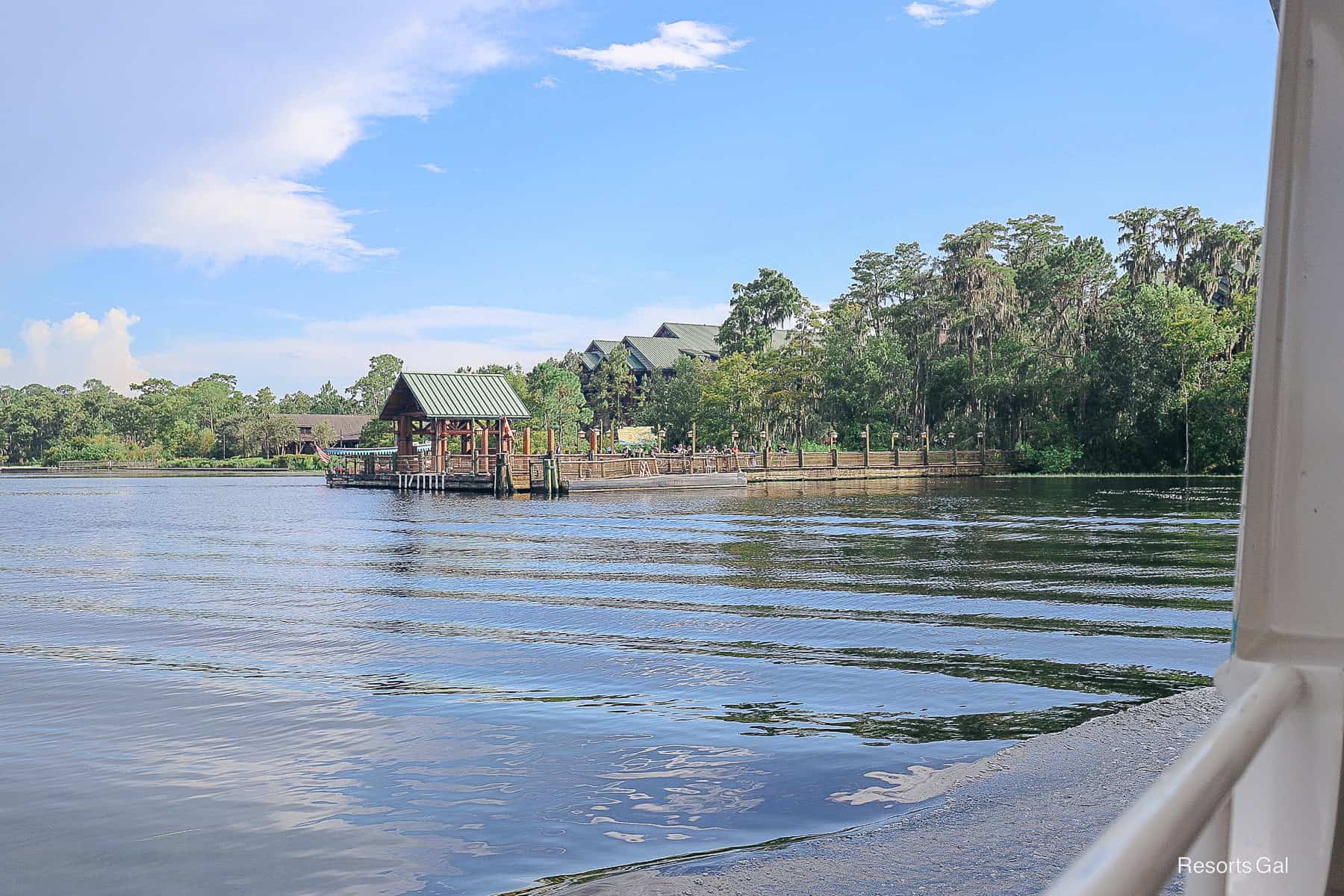 a boat traveling toward the dock of the Wilderness Lodge 