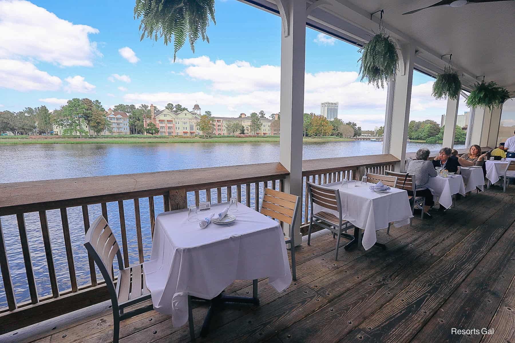 a row of tables along the restaurant's outdoor deck 
